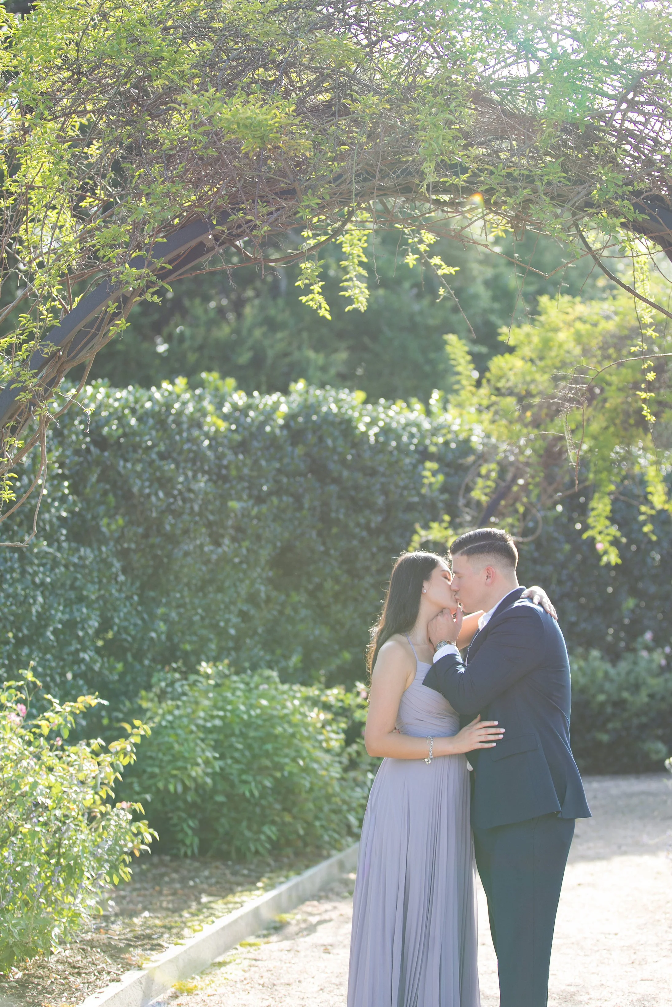 Couple kissing during romantic engagement portrait session in Houston