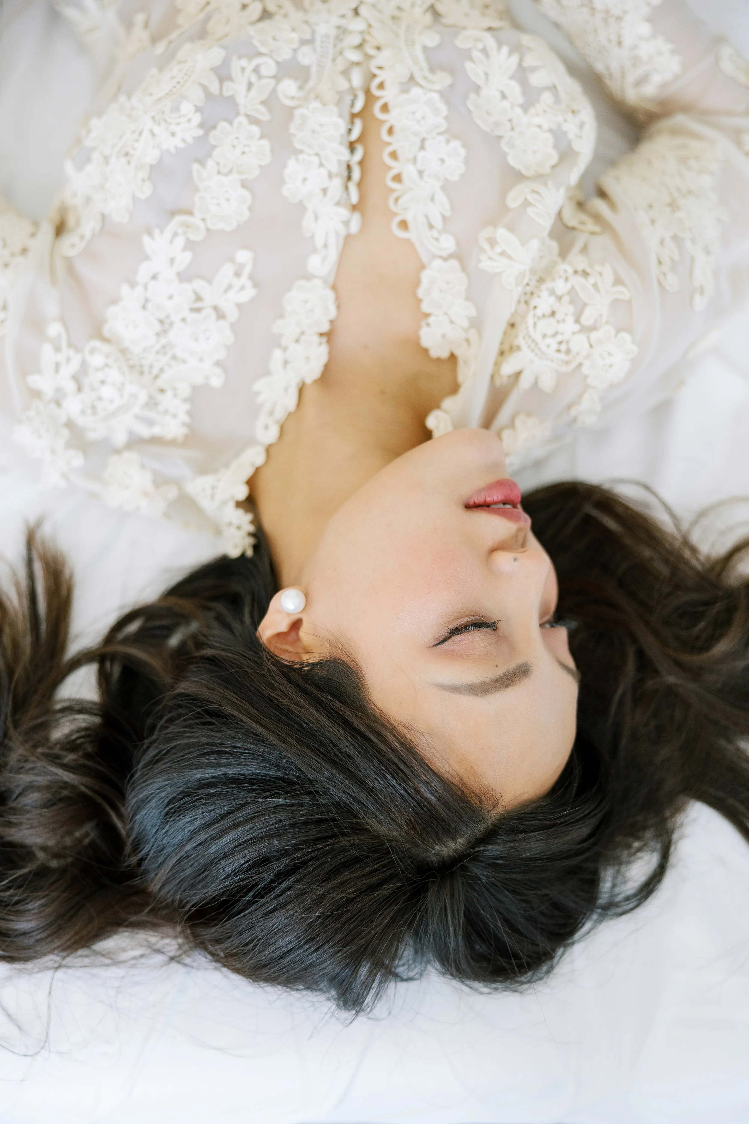 Woman laying down wearing a lace robe