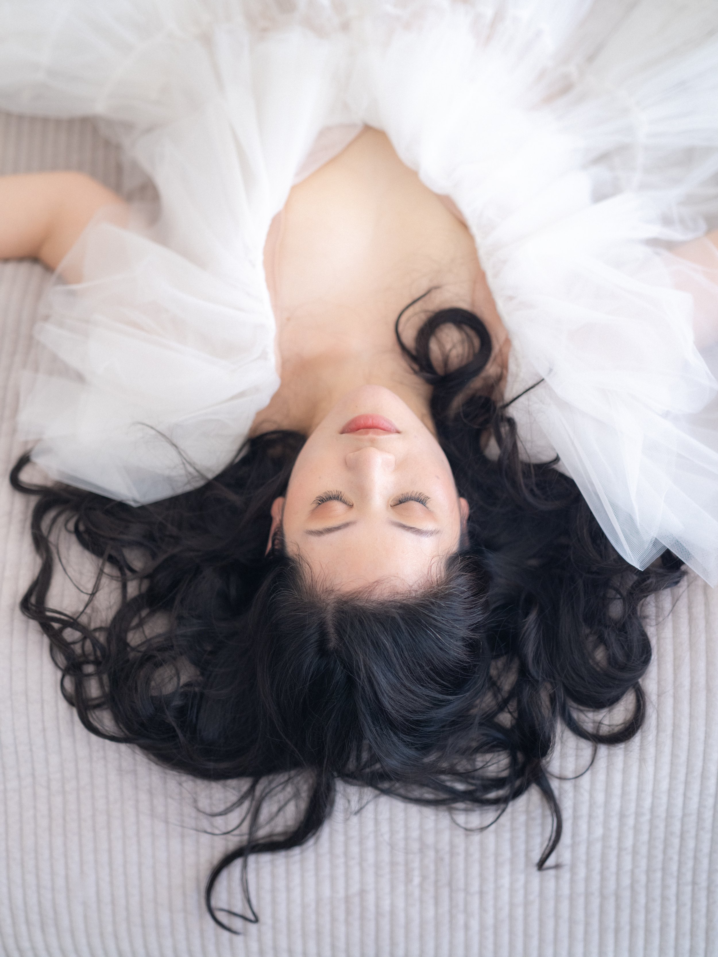 an woman laying down with her hair spread about