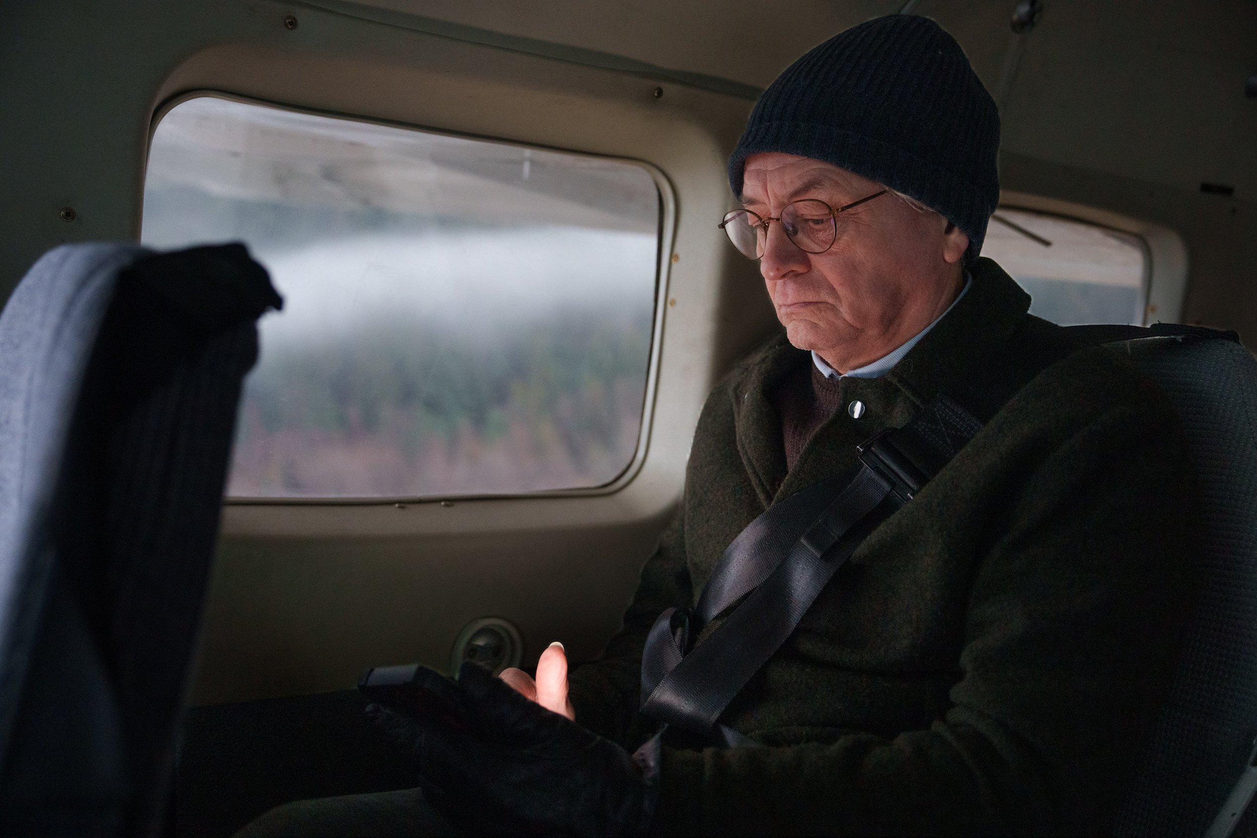 Tom in plane_working_lit phone screen.jpg