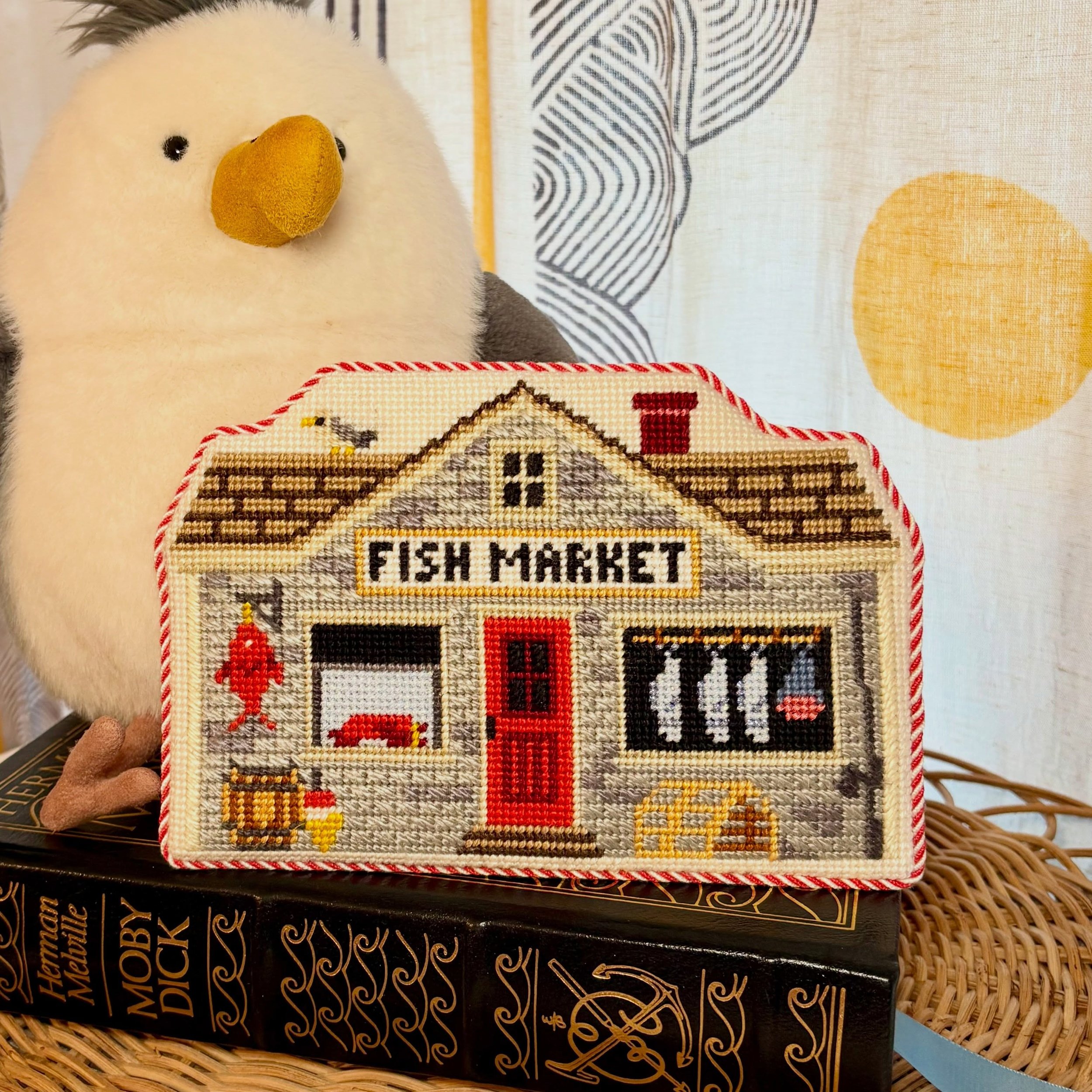 The @morganjuliadesigns fish market Finished as a hidden acrylic foot standup for @azdodds (it&rsquo;s so cute). We brought out the red in the project with the cording and backing fabric and @finishingfairy had the best tutorial to keep the back clea