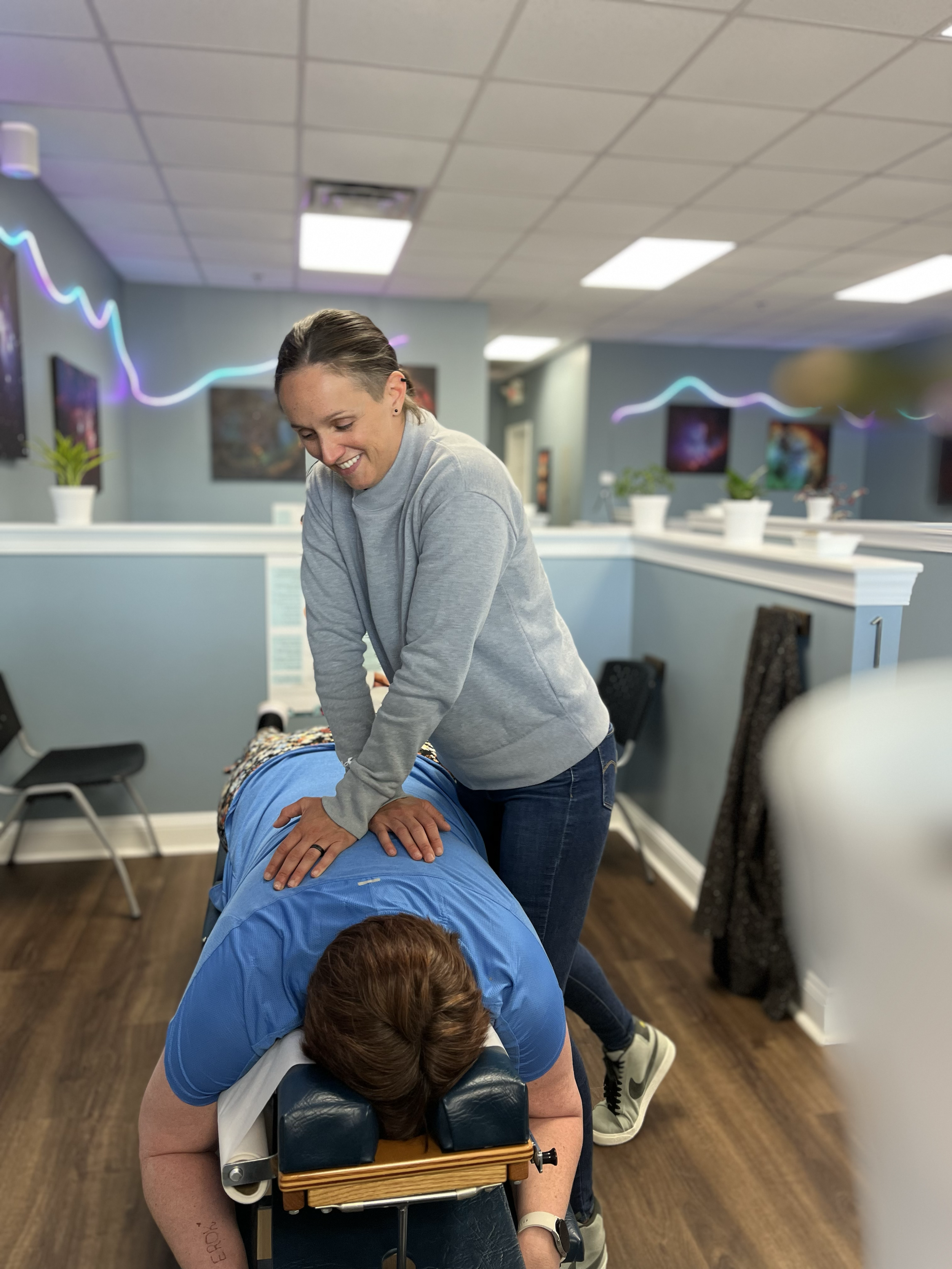 Dr. Jen giving a chiropractic adjustment at ChiroPure in Concord.