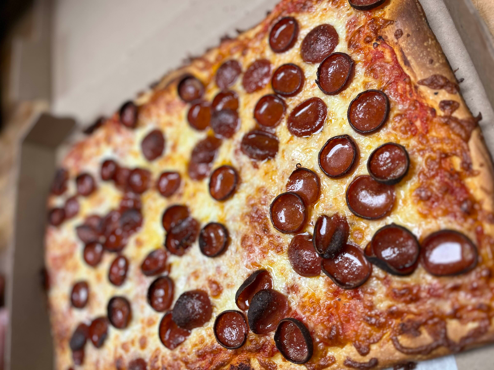 Perfectly cooked large pepperoni and cheese pizza prepared to go.