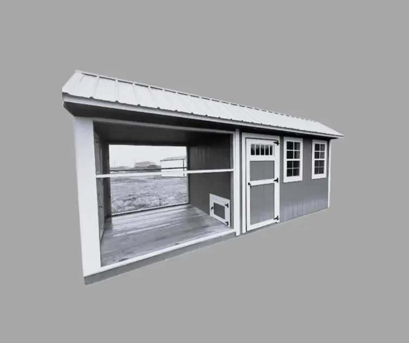 A small chicken coop with a sloped roof, multiple windows, and a door. It appears to be partially open at the front, showing an open interior space with a wooden floor and railing.