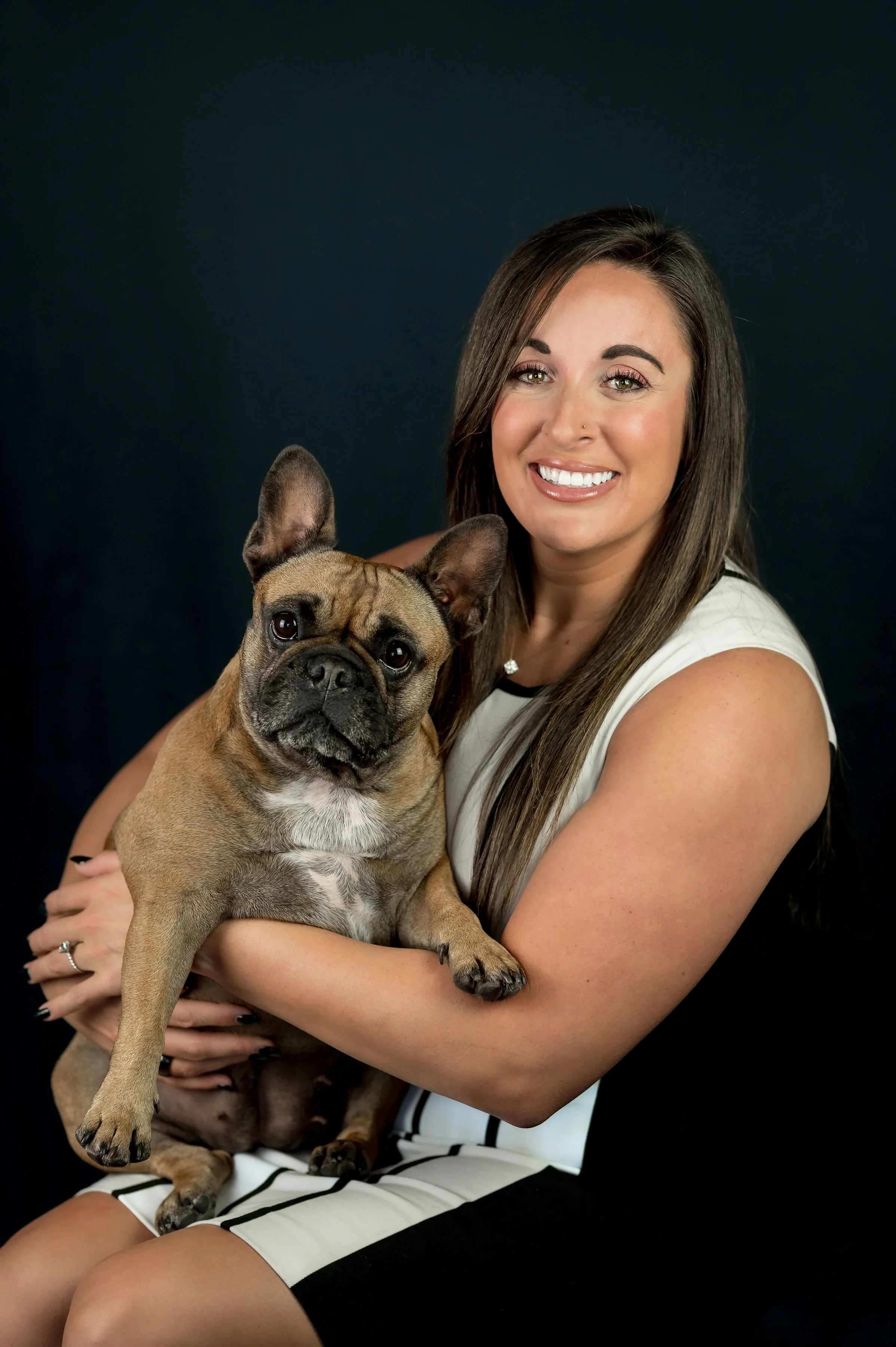 A woman sitting on a park bench near a body of water during the daytime.