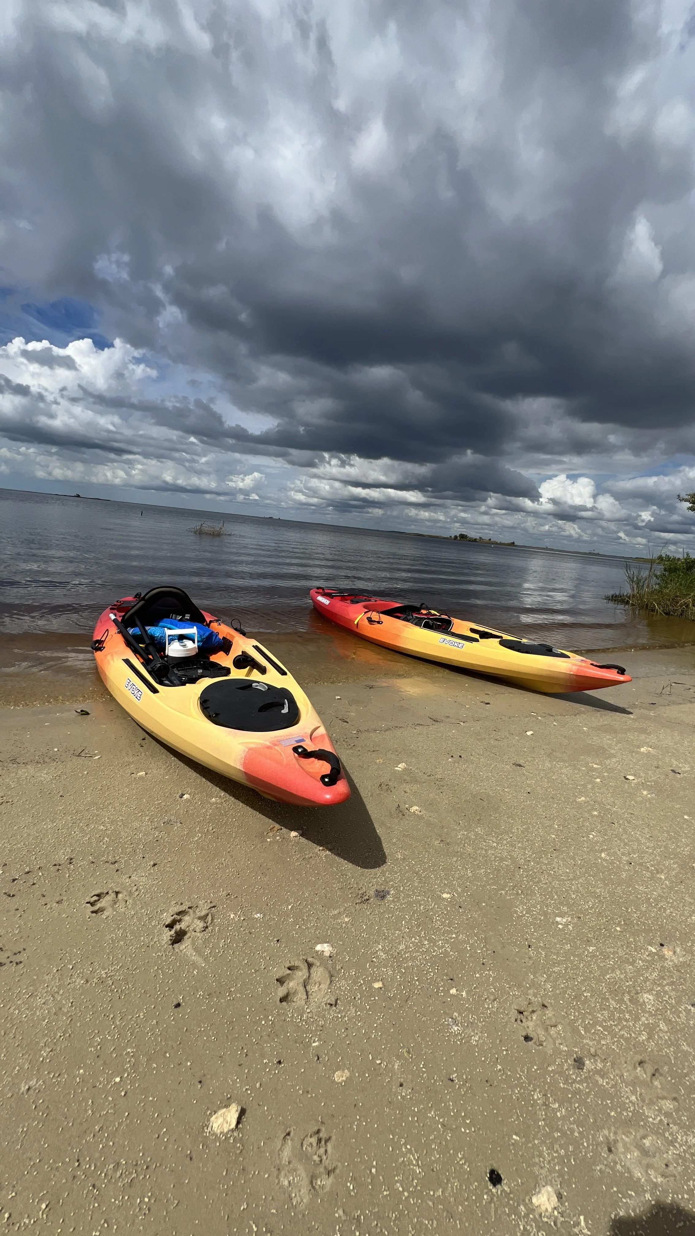 Two kayaks on a sandy beach