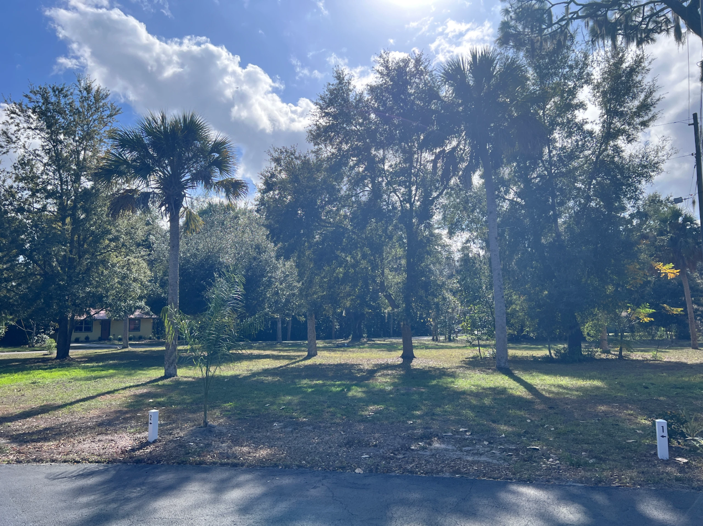 Sundown Republic camp site 1. Grass with shade trees and next to the garage.