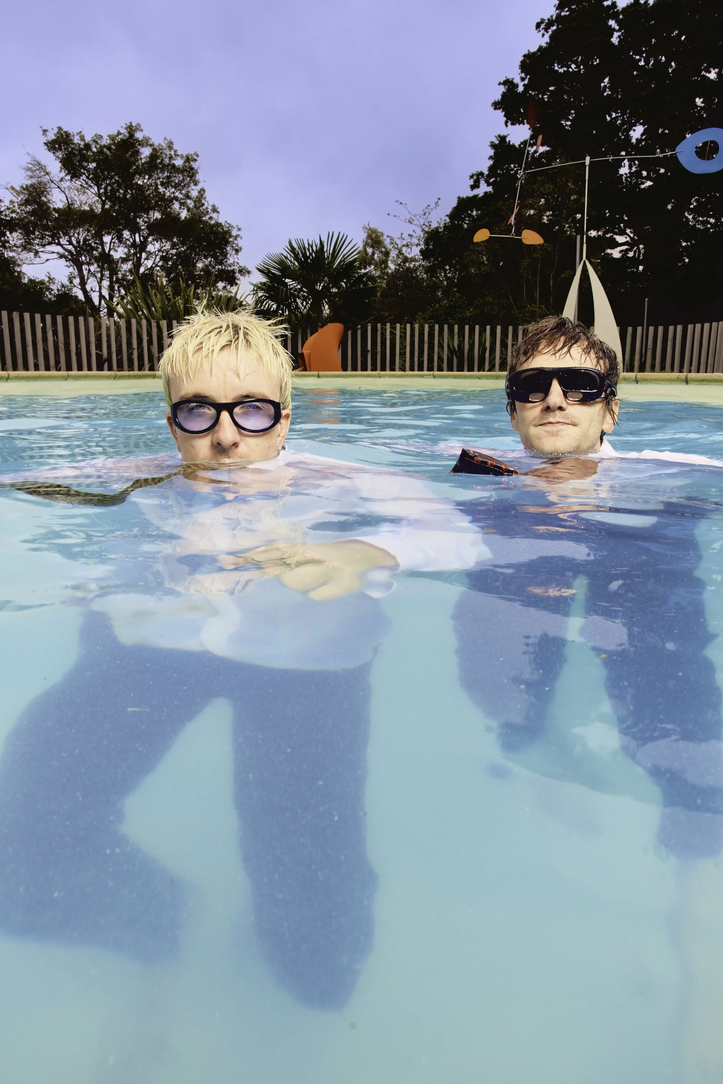 Good Neighbours British duo, in a pool wearing suits