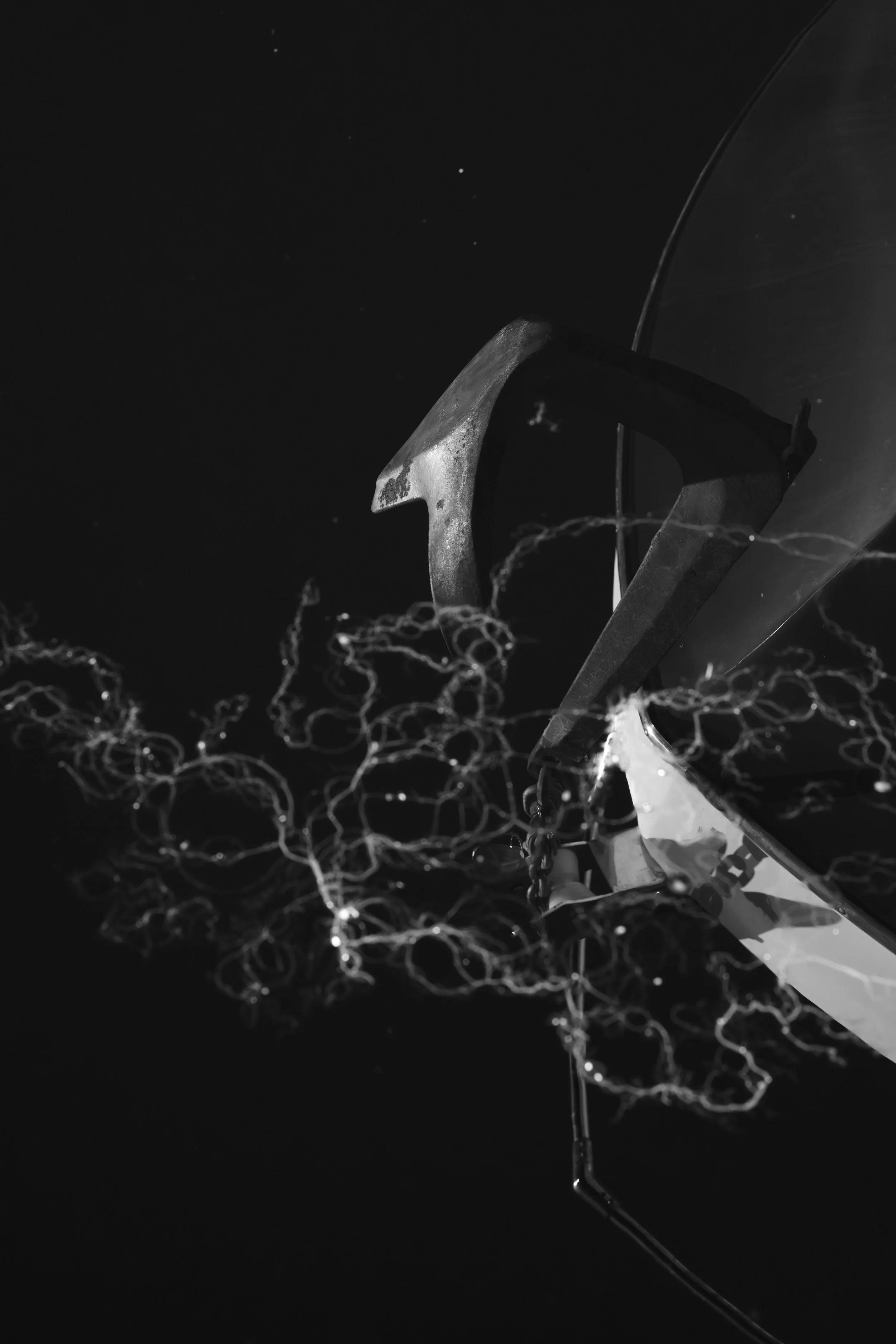 A black and white photo of a spacecraft's solar panel with electrical sparks or lightning around it in space.