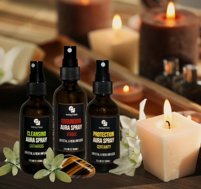 Inviting Effects Aura Sprays shown with crystals, sage and candles.