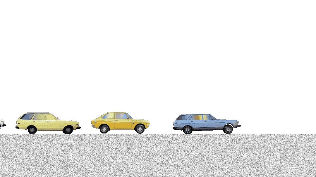 A line of four cars in different colors parked on a street with a grassy area behind. The street has a gray, textured surface.