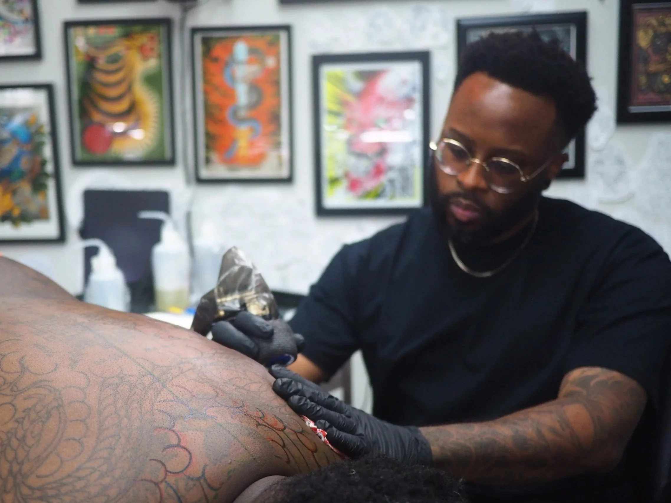 Japanese style tattoo artist Wes Holland working on a back piece in Atlanta