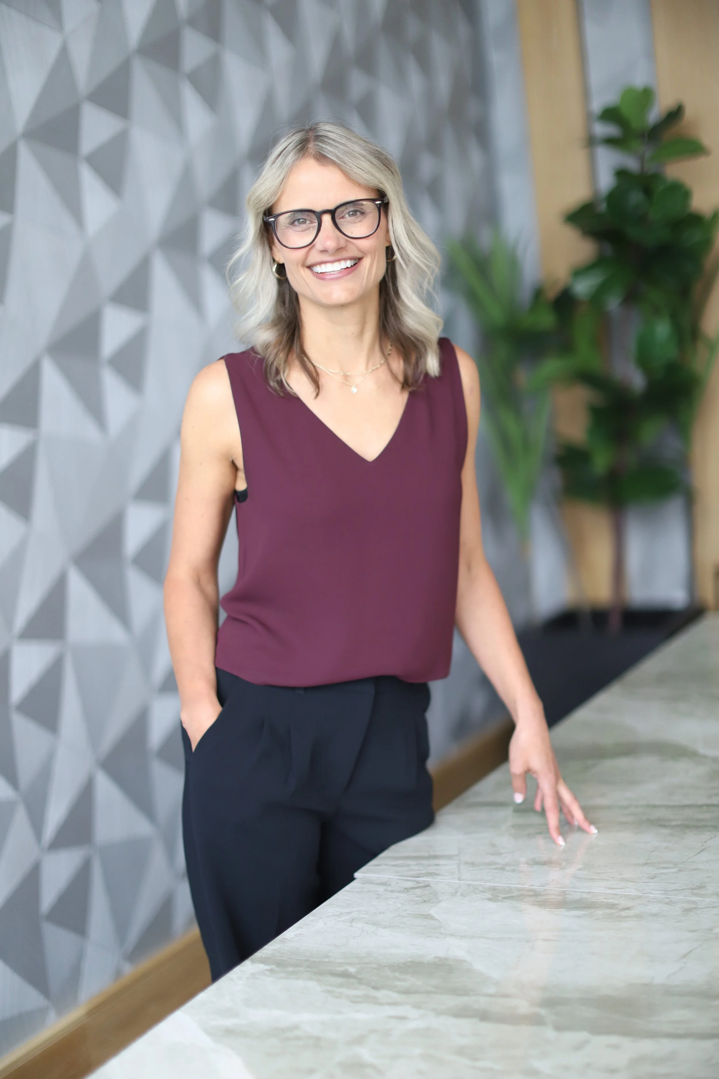 Jennifer standing at a boardroom table