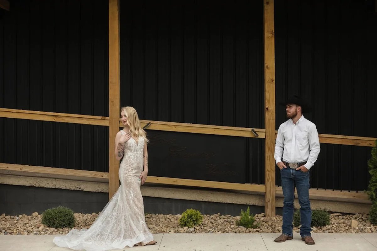 Couple in front of God's Country Venue signage.