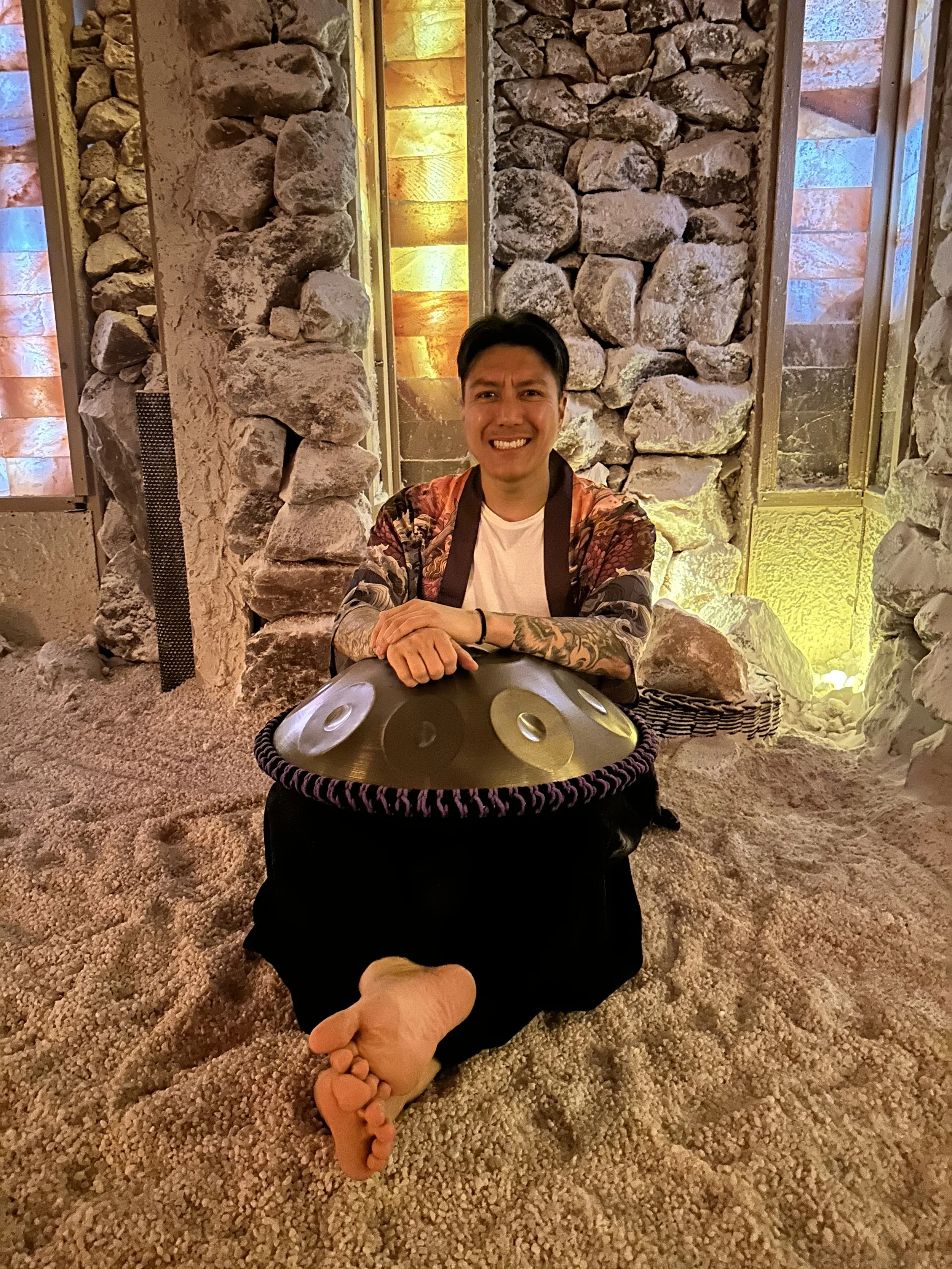 Alex Ma from Solar Soul Circle sitting with his handpan for a sound bath at the Saltwonder Himalayan Salt Cave in North Vancouver