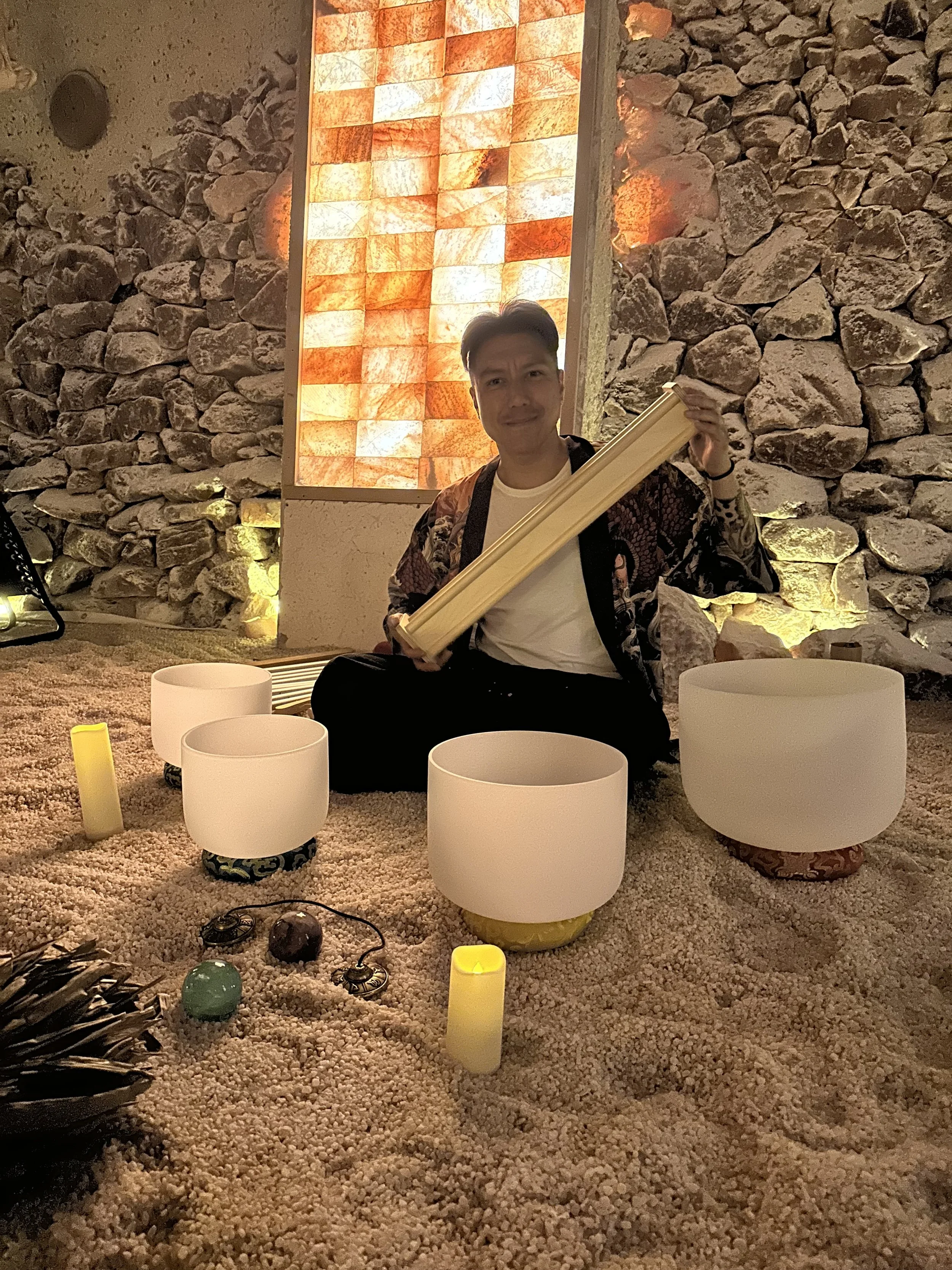 Alex Ma from Solar Soul Circle holding a rain stick for a sound bath at the Saltwonder Himalayan Salt Cave in North Vancouver