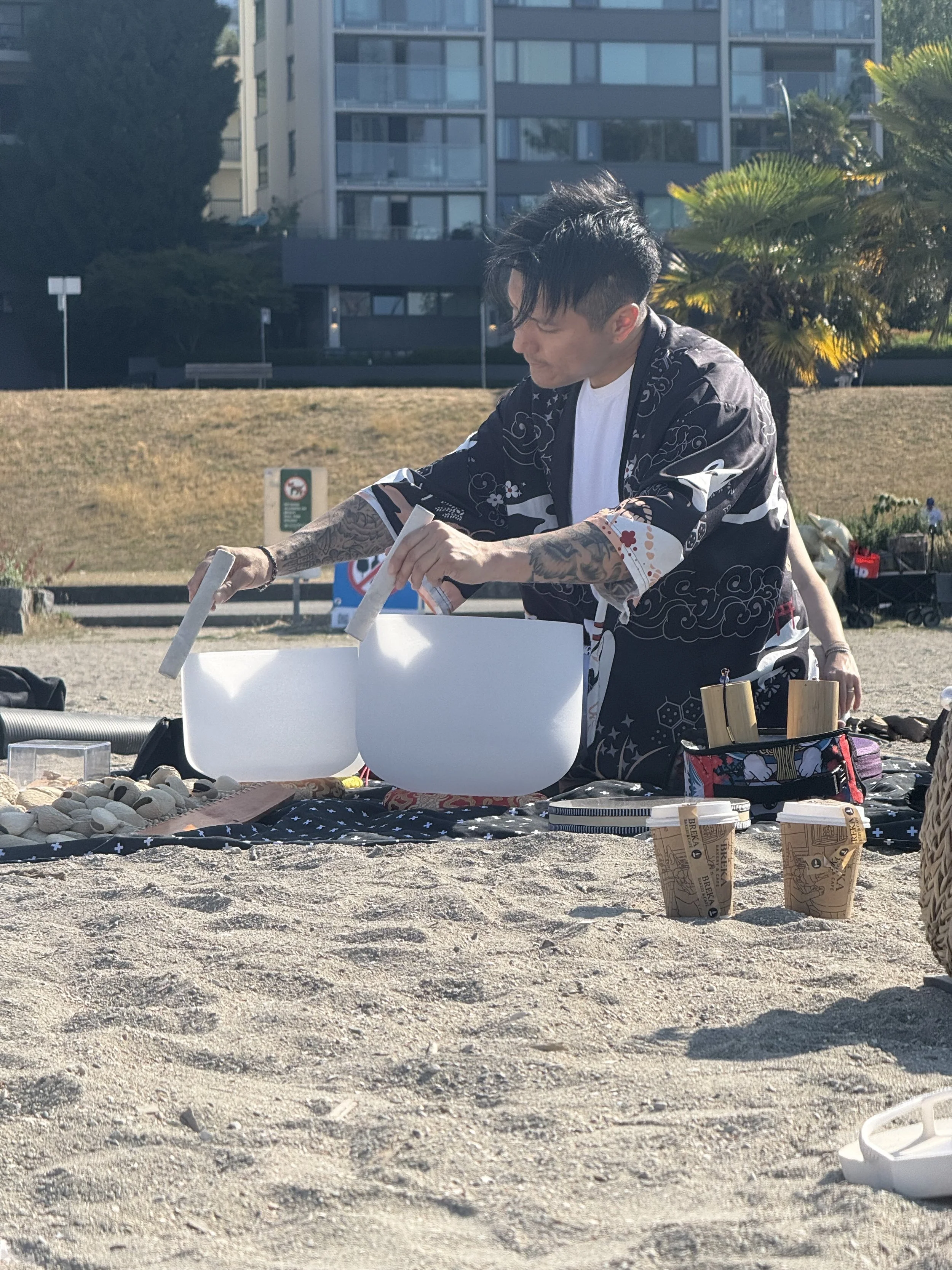 Solar Soul Circle sound bath at the beach in Vancouver. Alex Ma playing the crystal sound bowls