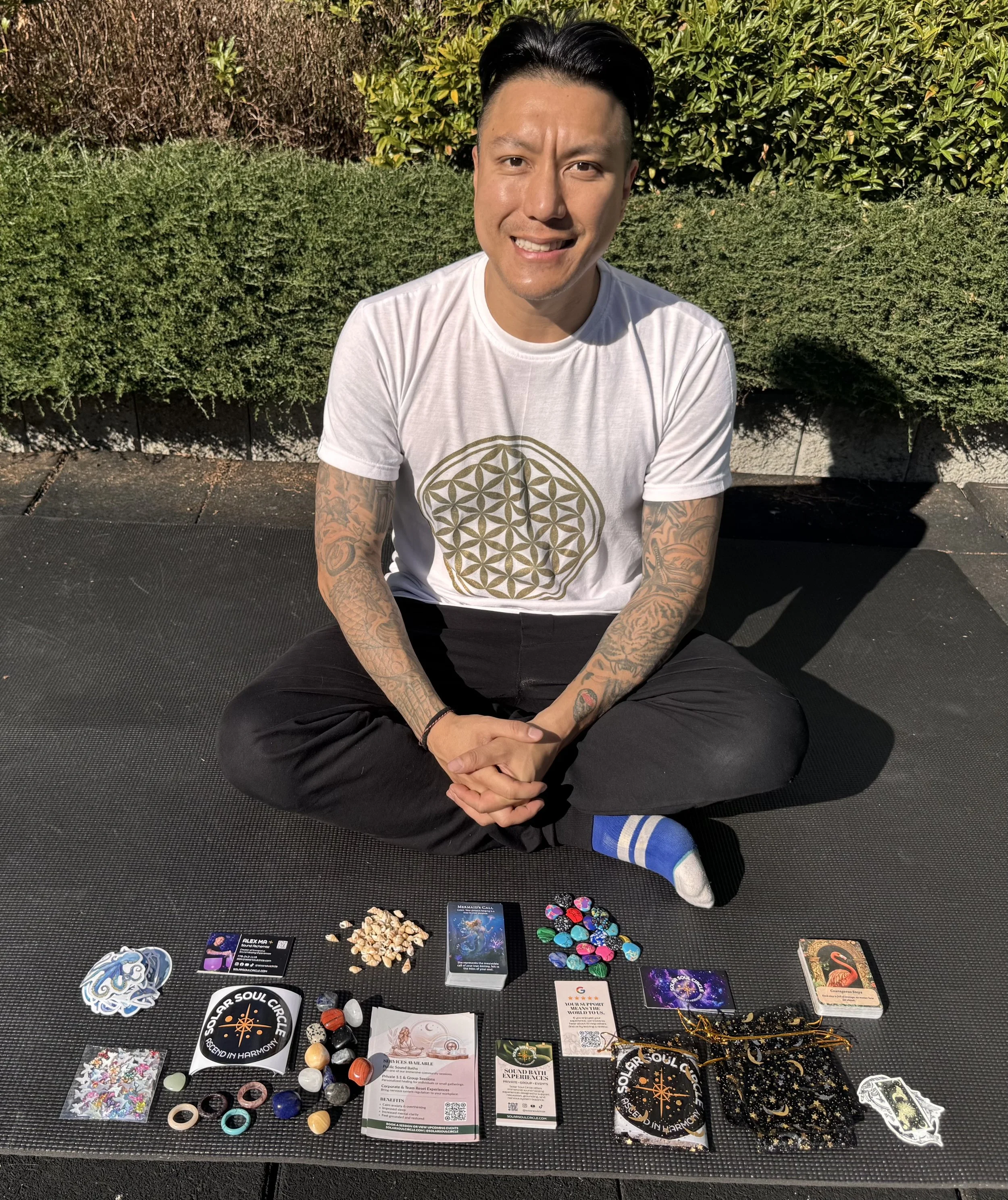 Alex Ma from Solar Soul Circle sitting with items for creating gift bags for guests of his sound healing sessions in Vancouver and the Lower Mainland.