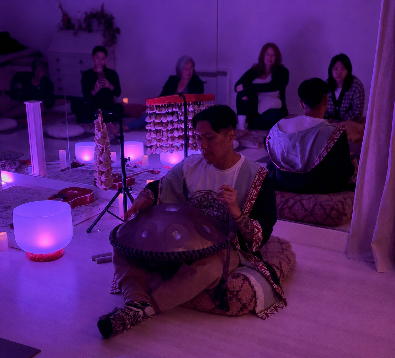 Bachelorette or bridal shower sound bath setup in Vancouver with crystal singing bowls, soft lighting, blankets, flowers, and calming event decor.