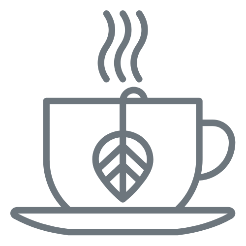 A steaming coffee mug with a leaf design on it, placed on a saucer.