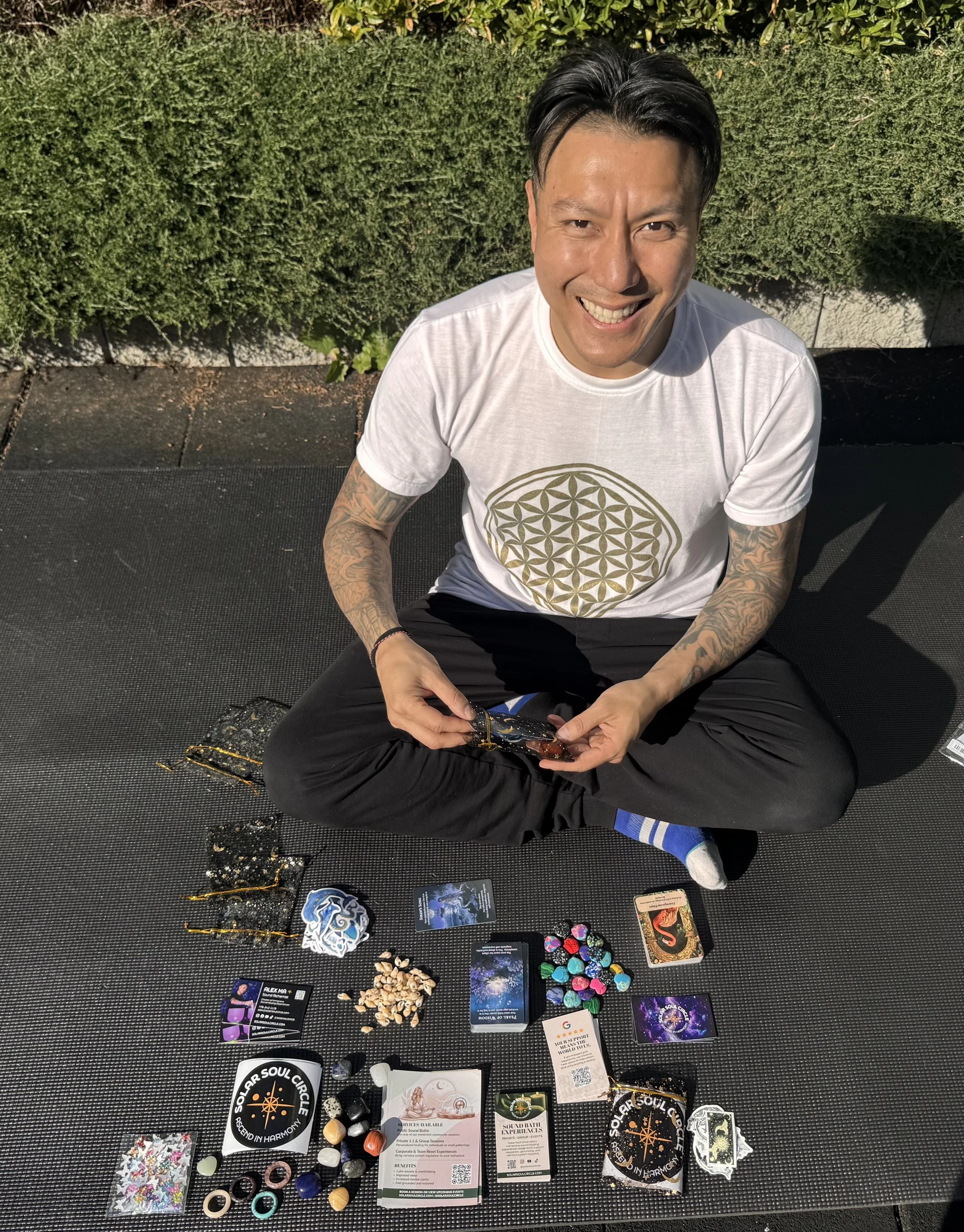 Alex Ma smiling while putting together a gift bag for his sound healing clients who attend his next corporate wellness sound bath event in Vancouver.