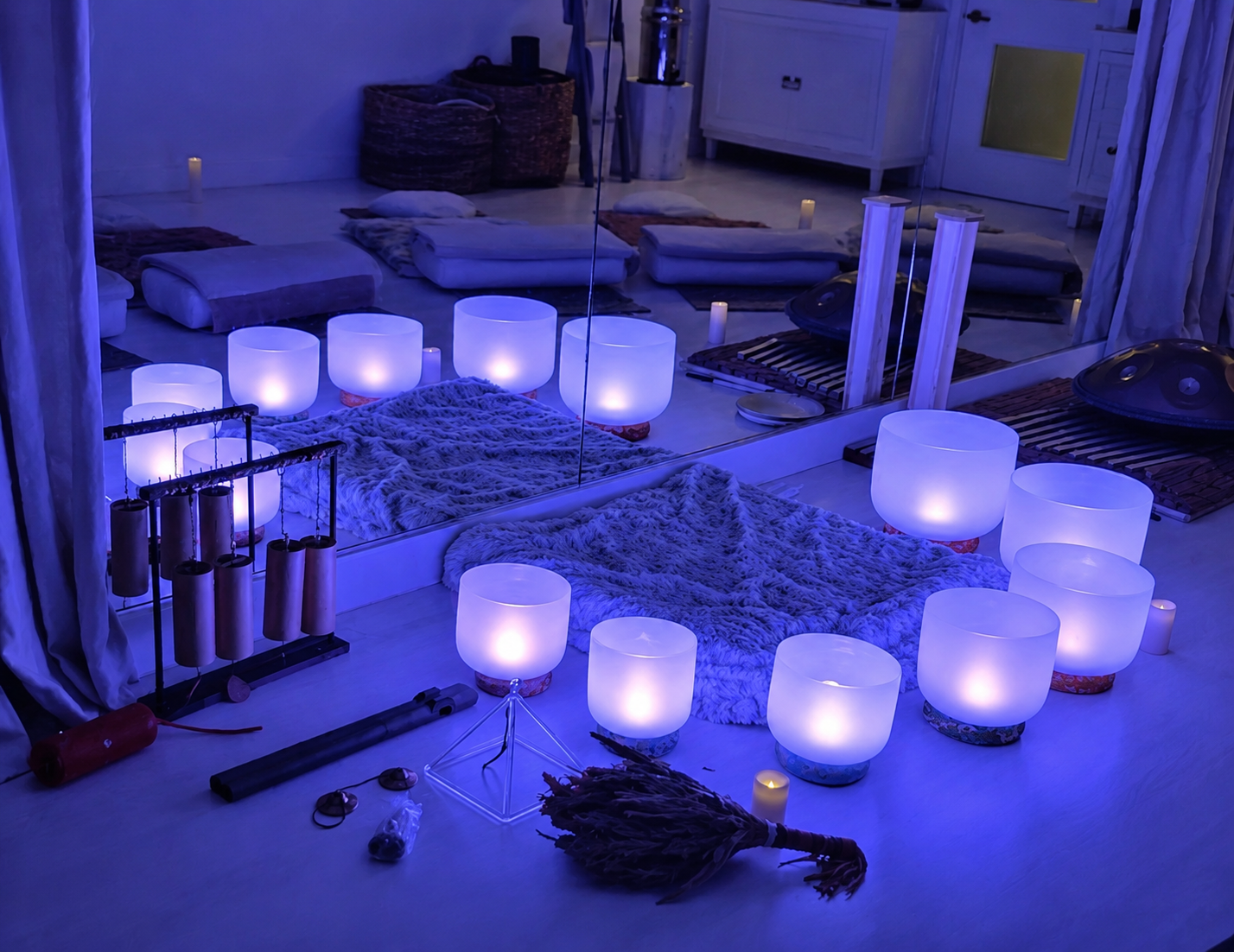 Sound healing instruments for a special event sound bath in Vancouver, including crystal singing bowls, handpan, chimes, ocean drum, rain stick, and crystal pyramid.