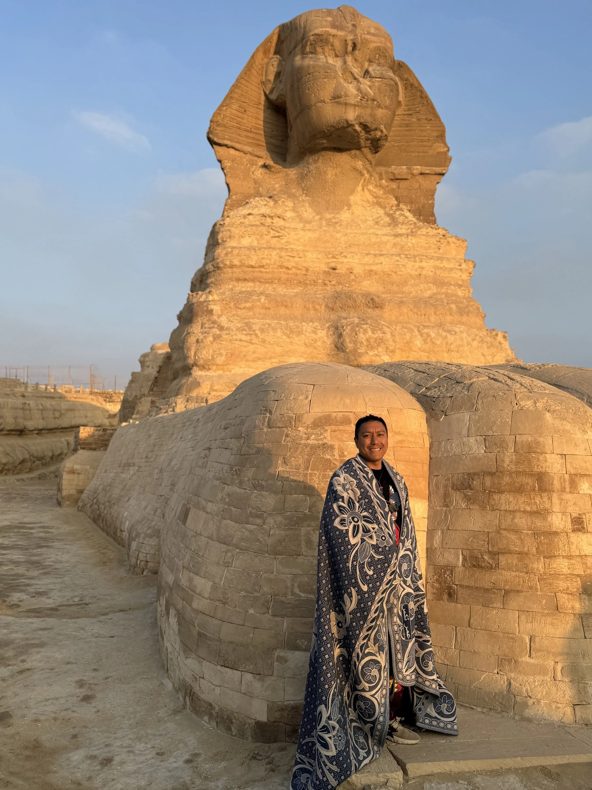 Alex Ma at the Great Sphinx in Egypt, connecting sacred travel, spiritual inspiration, and the roots of Solar Soul Circle sound healing in Vancouver.