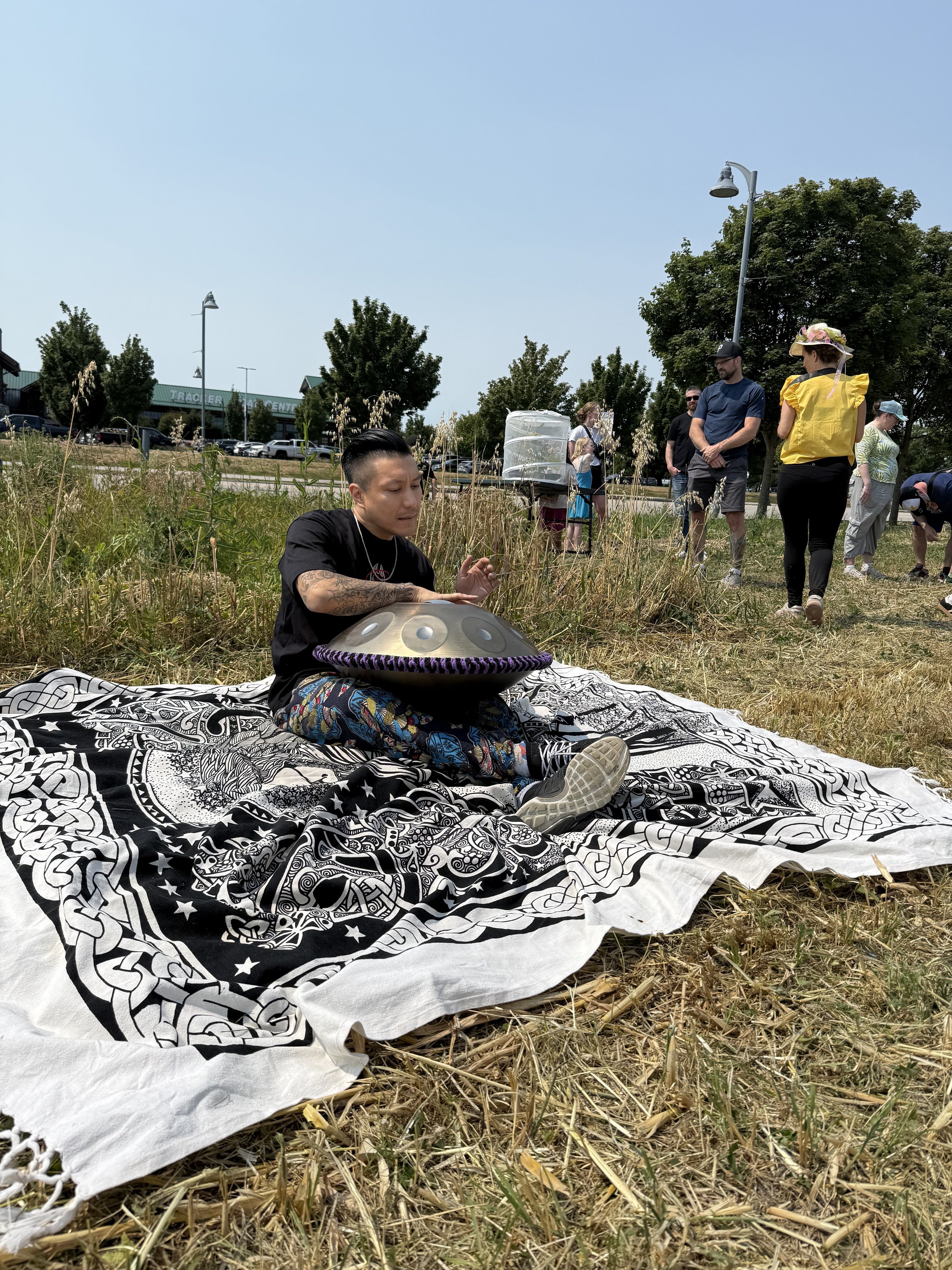 Alex Ma from Solar Soul Circle playing the handpan at the grand opening of Petal Paradise