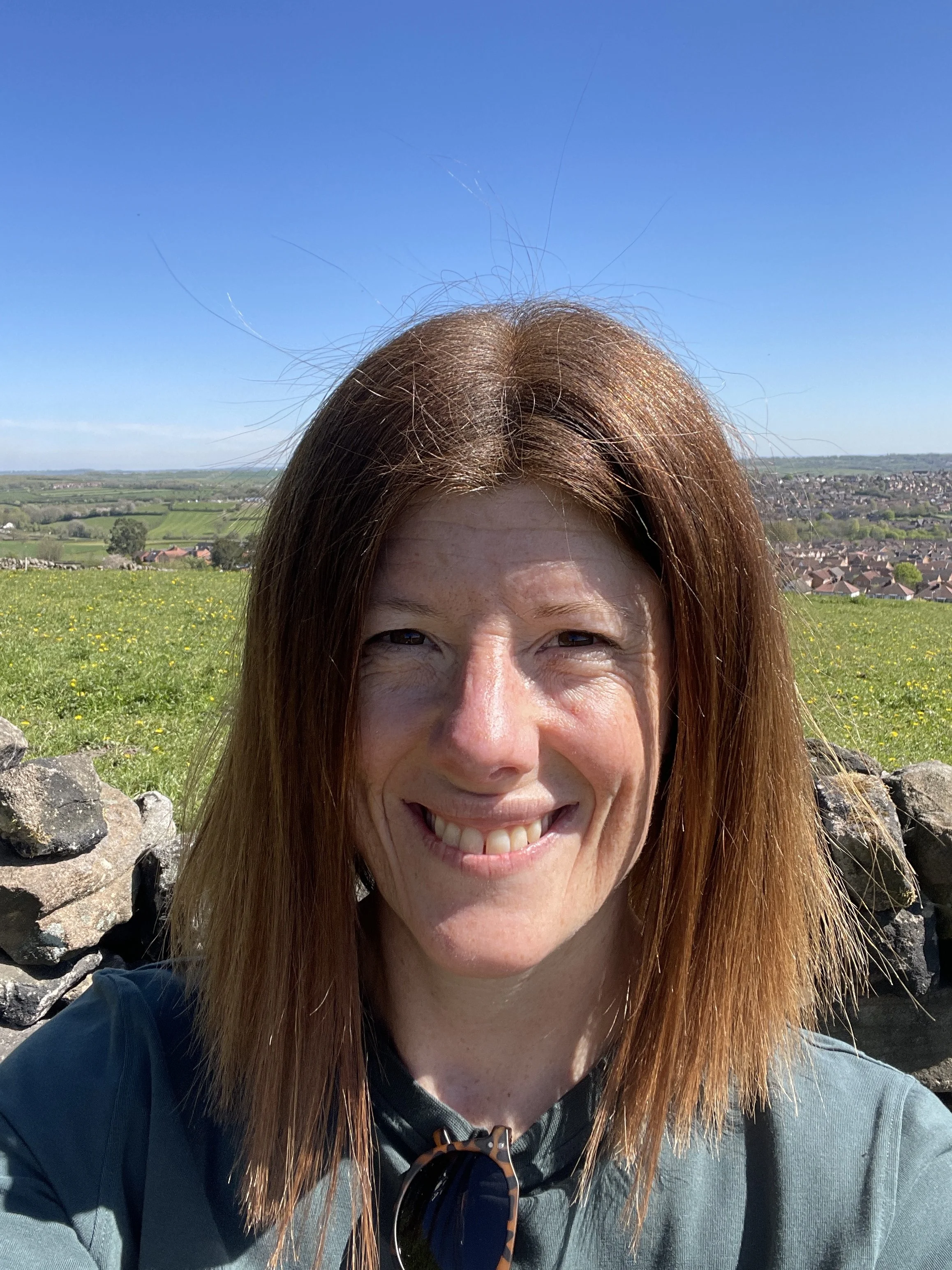 Woman standing in a field on a sunny day