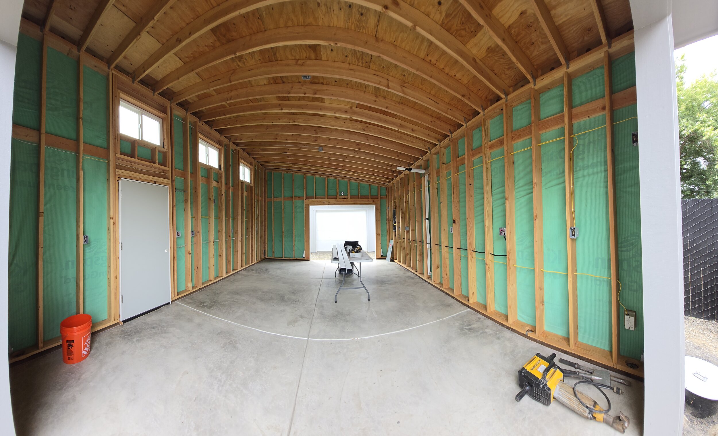 Detached garage drywall installation in Eugene’s Friendly Area, including wall and ceiling hanging, taping, finishing, and application of a light orange peel texture. Window returns were finished with a clean four-way square detail for a sharp, moder