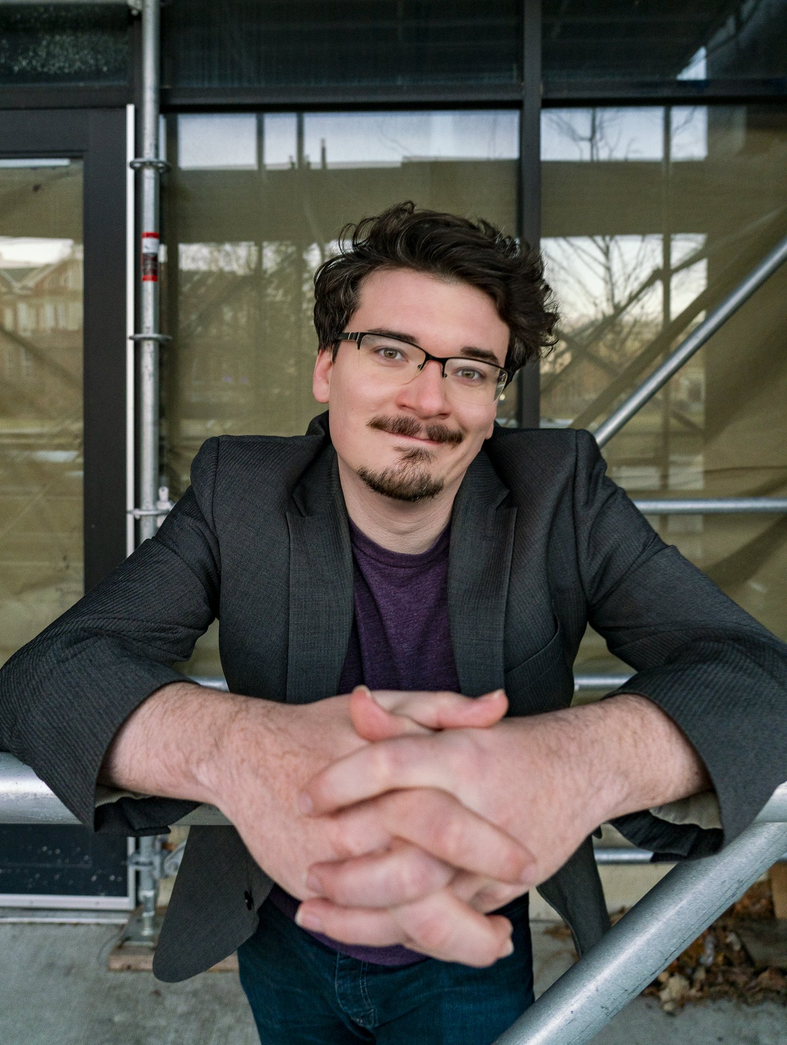 Tim Overton, his hands clasped. Corporate training available for event entertainment and team building workshops on listening, leadership, teamwork, and creative building within a growth mindset.