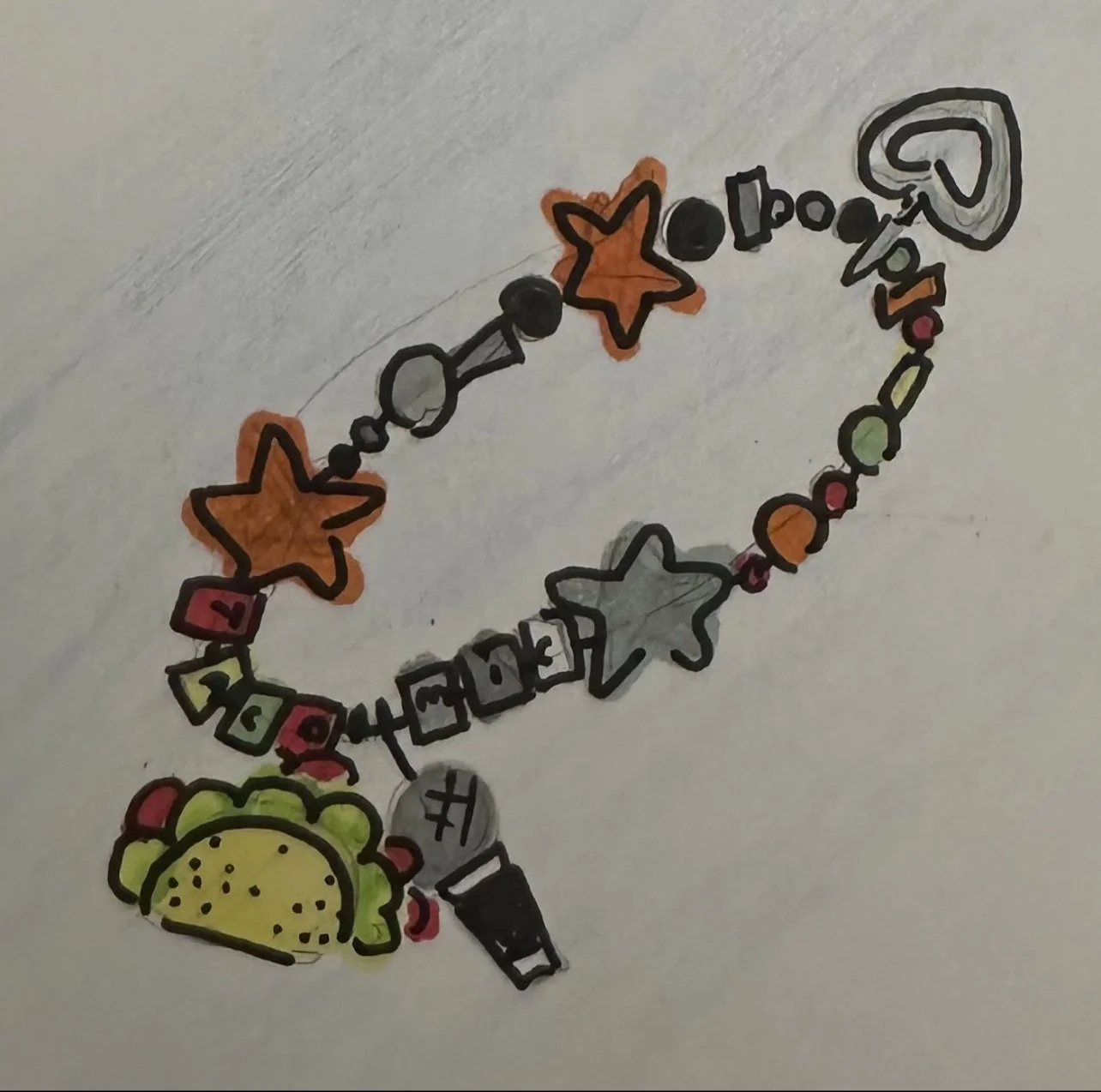 Colorful beaded bracelet with star, heart, taco, and other charms, some with words like 'Lucky.'