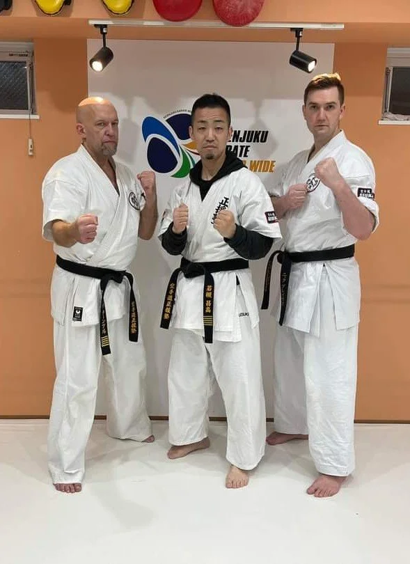 Sensei Nick, Kaicho Wakatsuki and Kyoshi turnbull pose in a dojo in Japan.