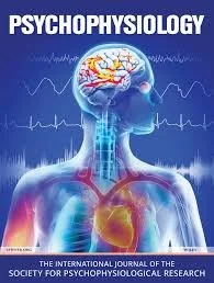 Cover of a psychology publication featuring a human figure with a brain and heart, emphasizing psychophysiology, with background of ECG lines.