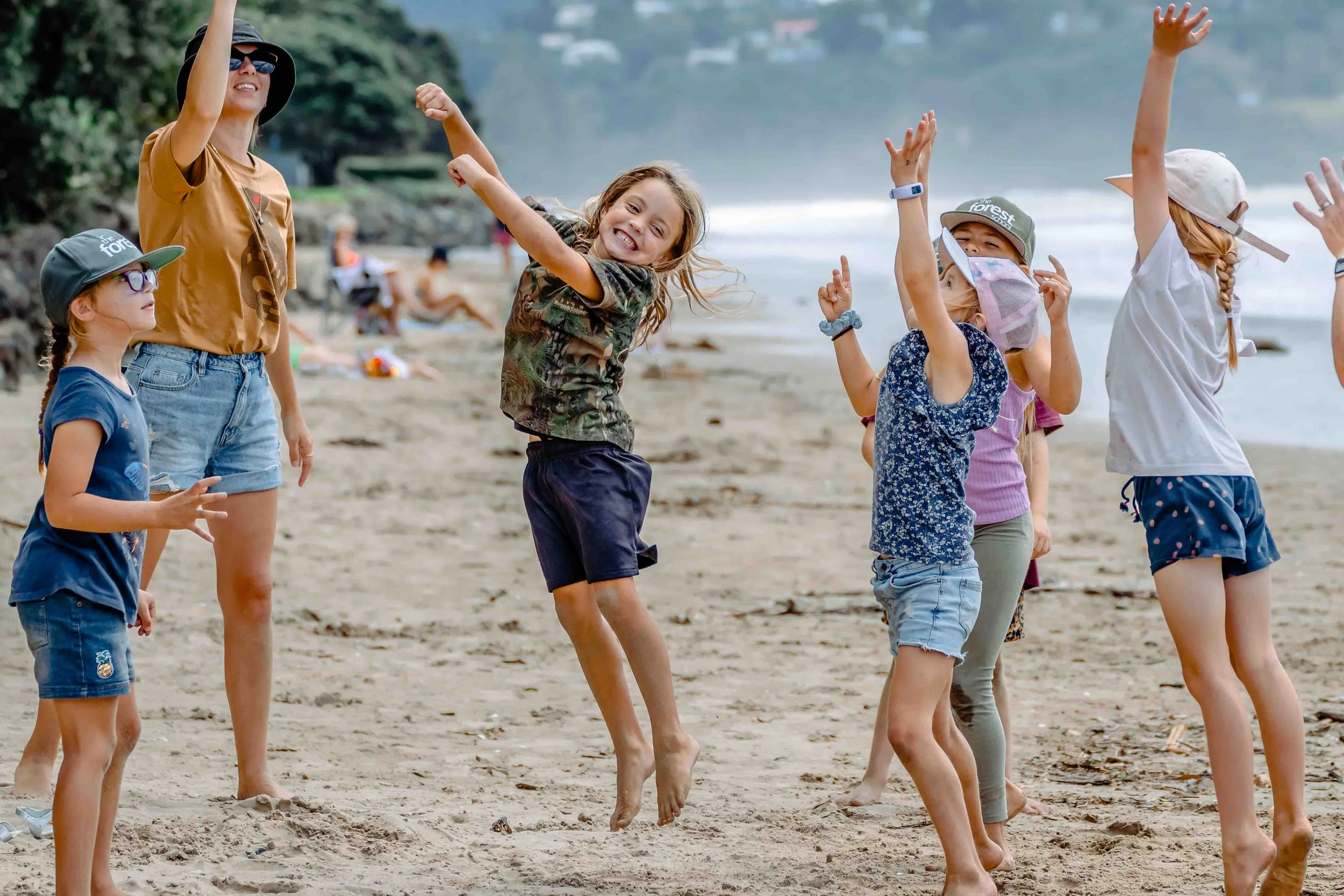 The Forest School students participating in group learning on the beach