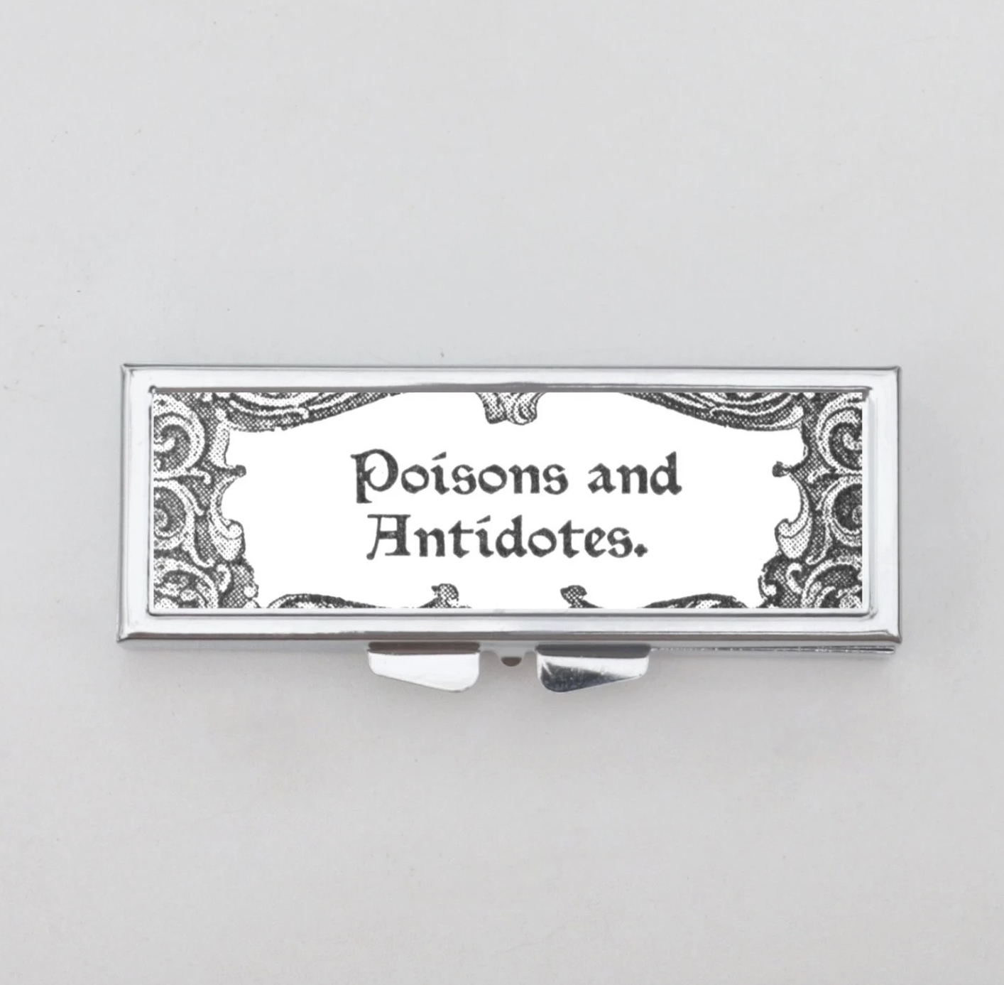 Poisons and Antidotes Pill Box by Compact Collection (via Etsy)