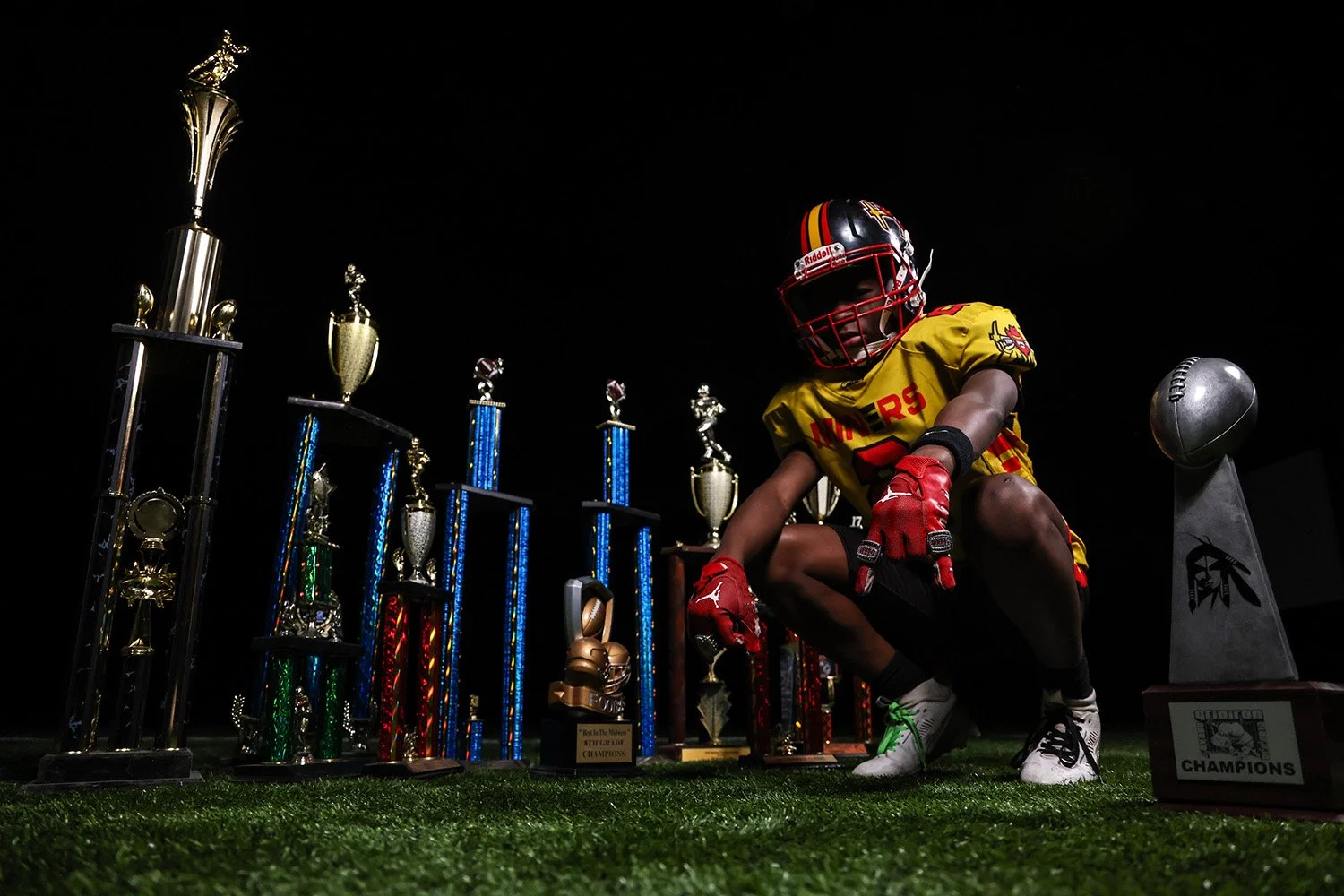 Midwest Miner football player with trophies
