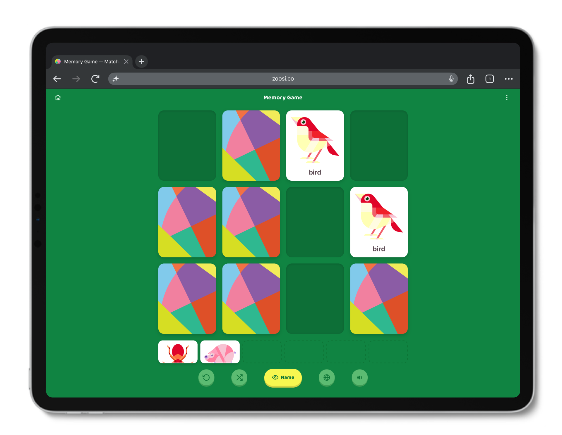 Tablet screen displaying a memory matching game with colorful and animal-themed cards. Two cards show a red and white bird with the label 'bird'.