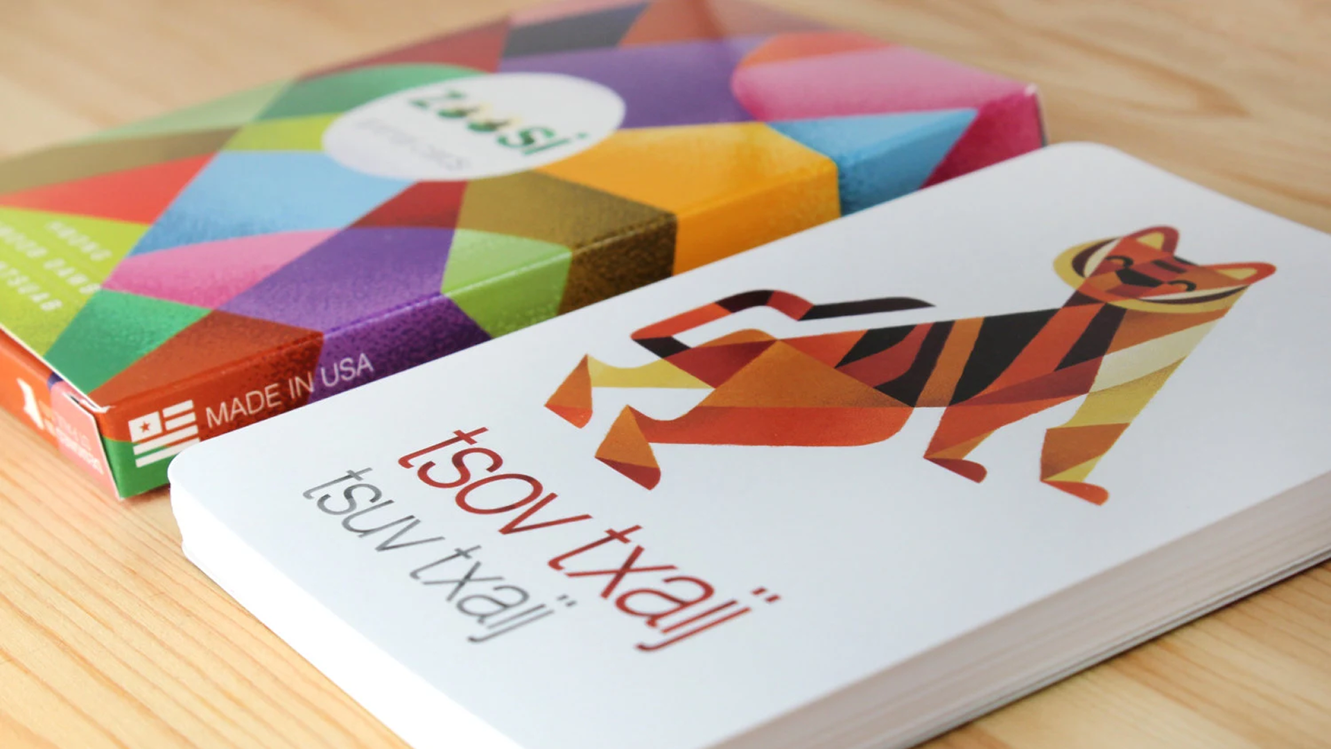 Colorful puzzle box featuring a geometric tiger illustration, with text in multiple languages about the product.