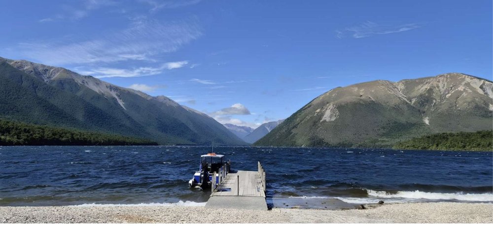 A jetty on the lake in Nelson Lakes National Park with mountains behind