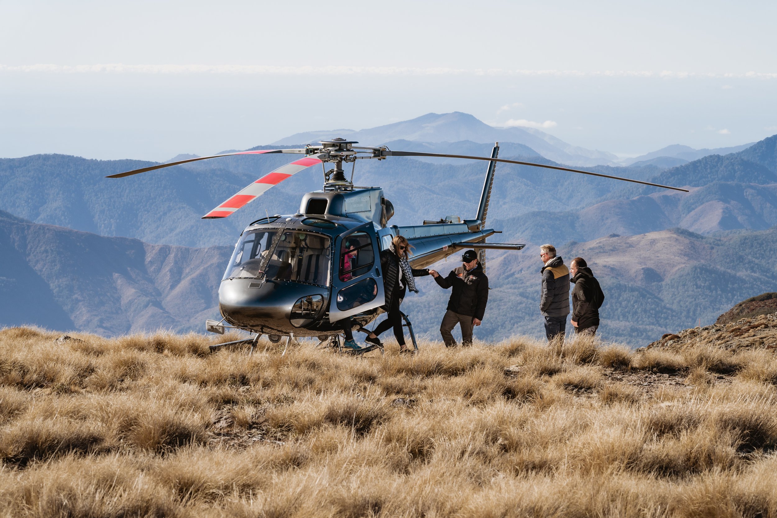 Guests boarding helicopter for heli-fishing in remote Nelson mountains