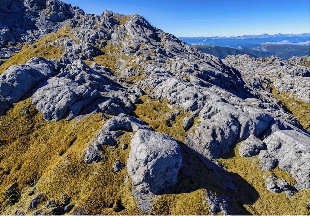 Glaciated marble karst on Mt Owen under a blue sky