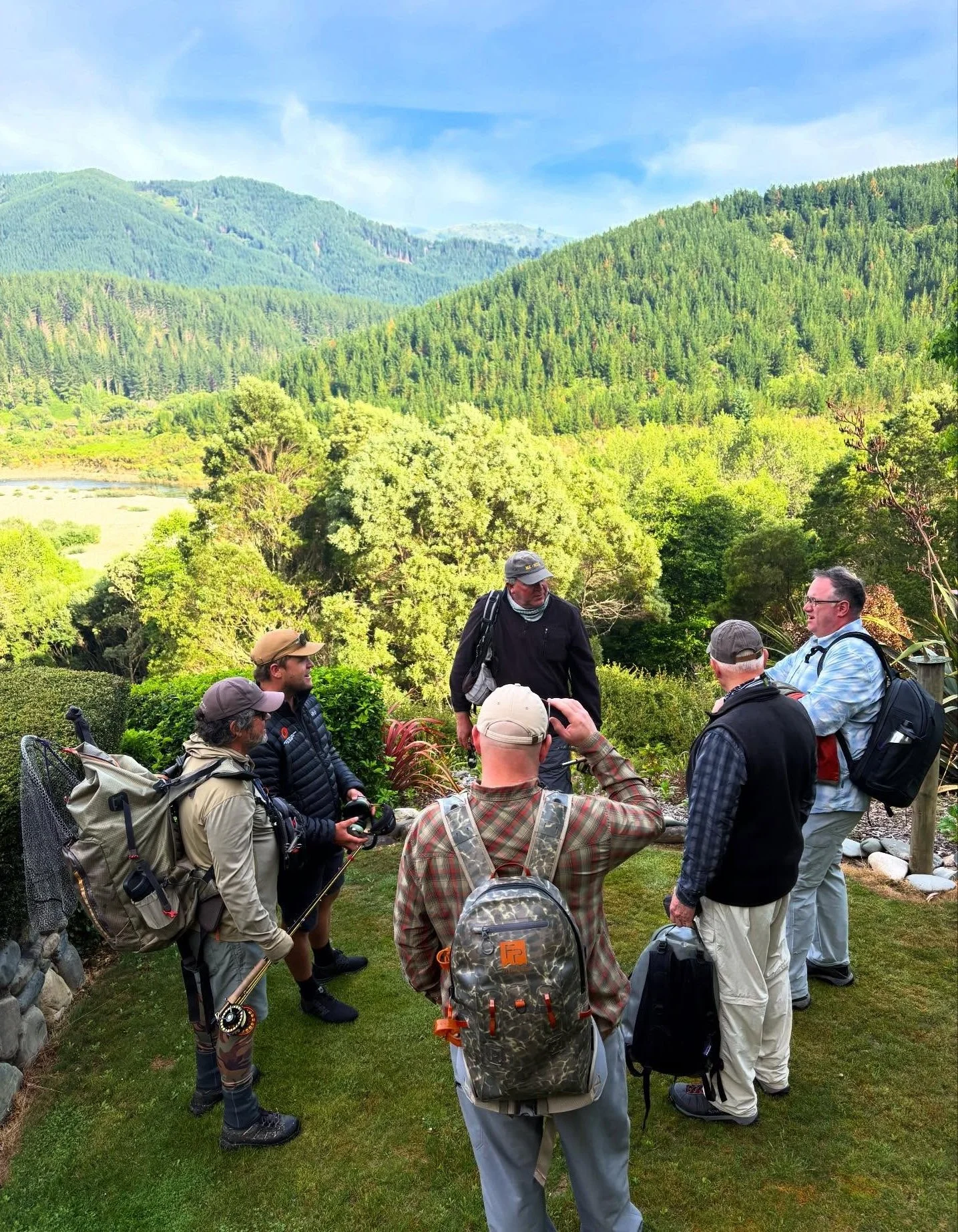 Guests preparing for heli-fishing trip with panoramic valley views at Stonefly Lodge