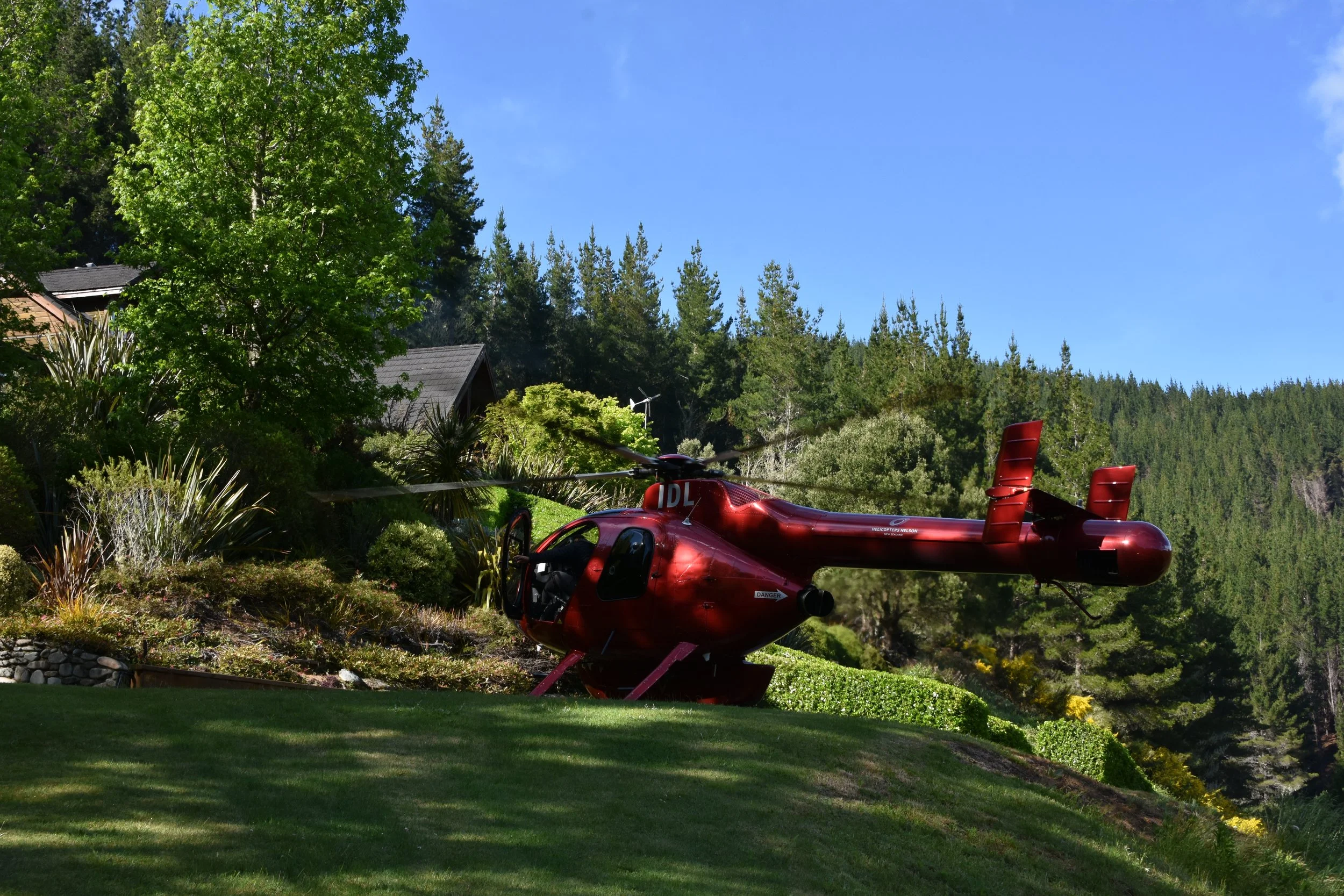Helicopter landing on Stonefly Lodge grounds for heli-fishing departure