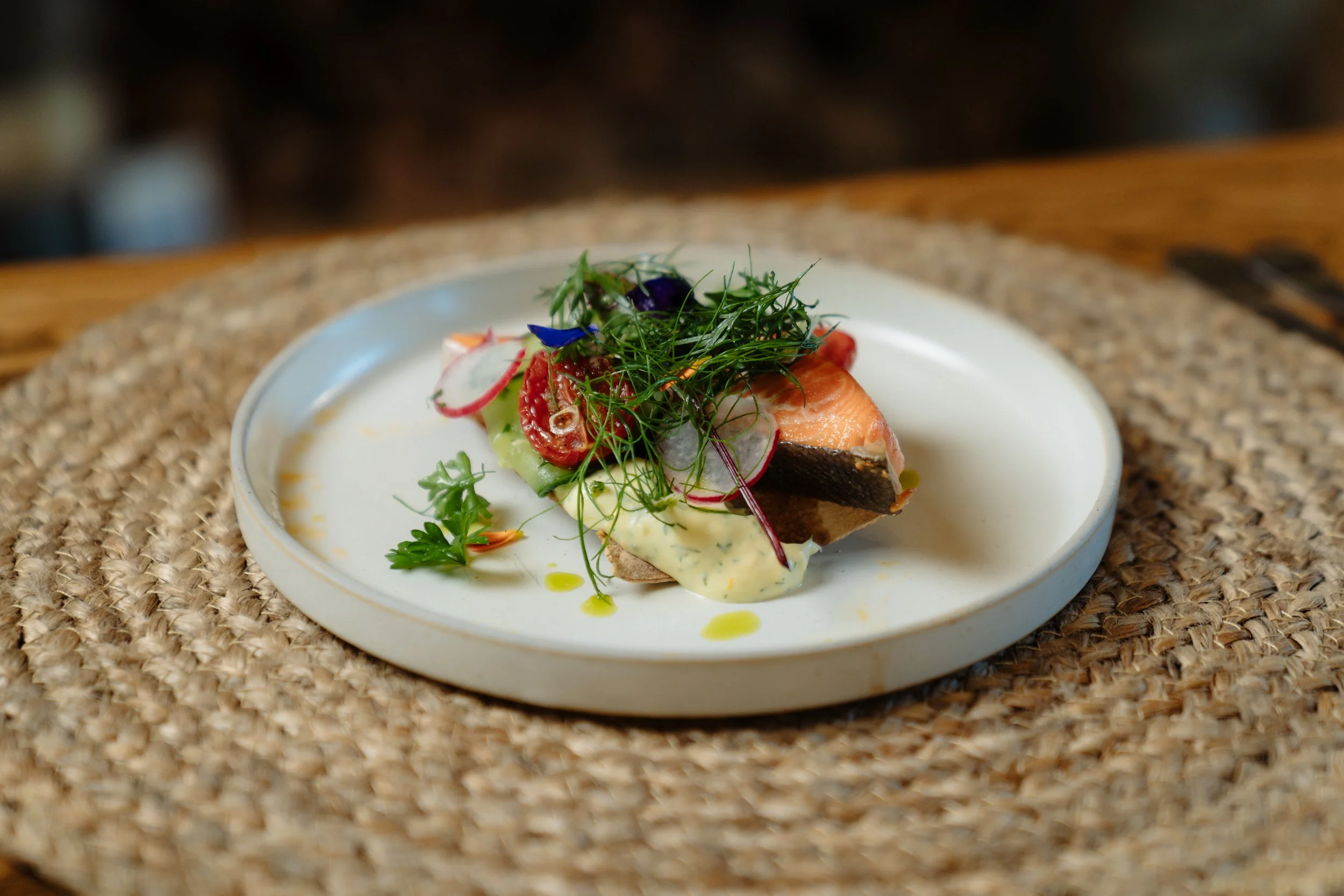 Seared fish dish with microgreens plated at Stonefly Lodge