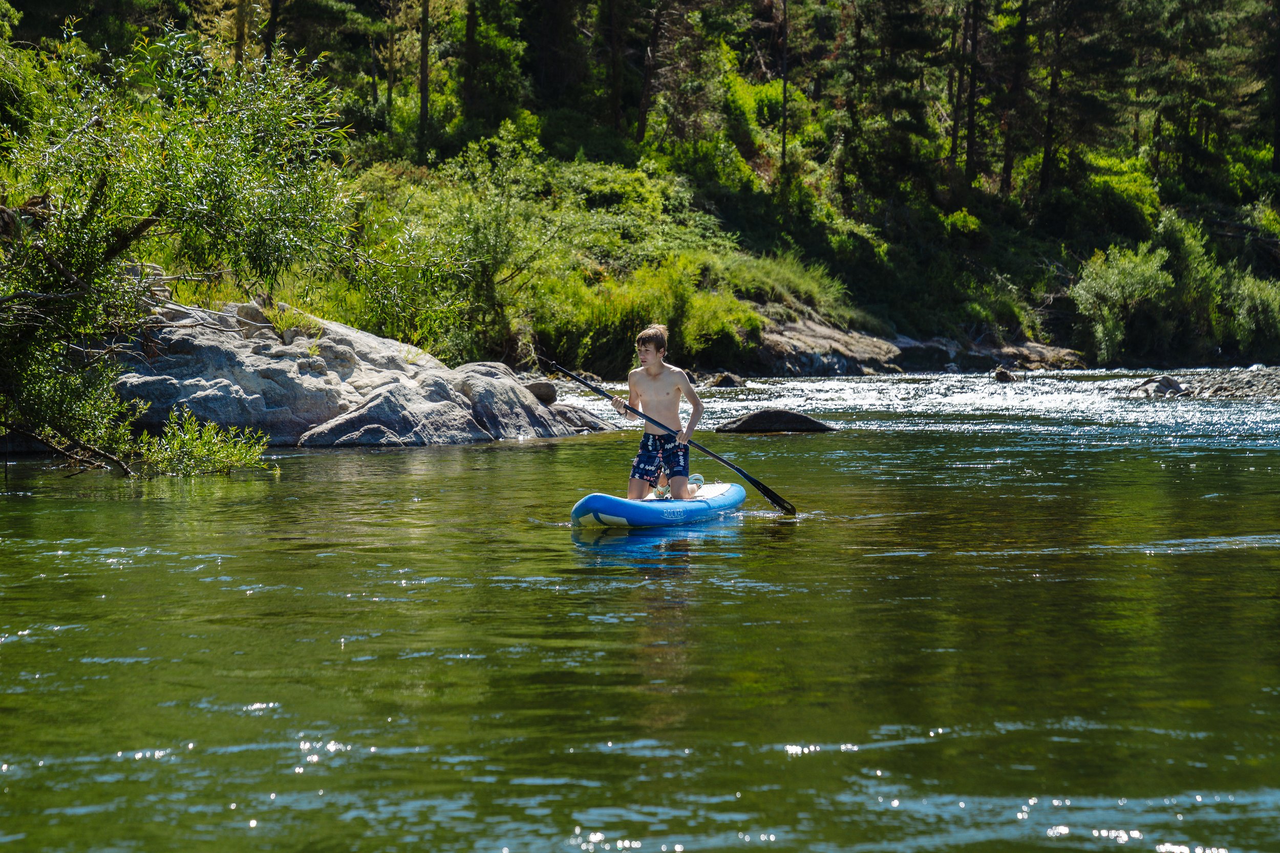Stand-up paddleboarding on the river near Stonefly Lodge