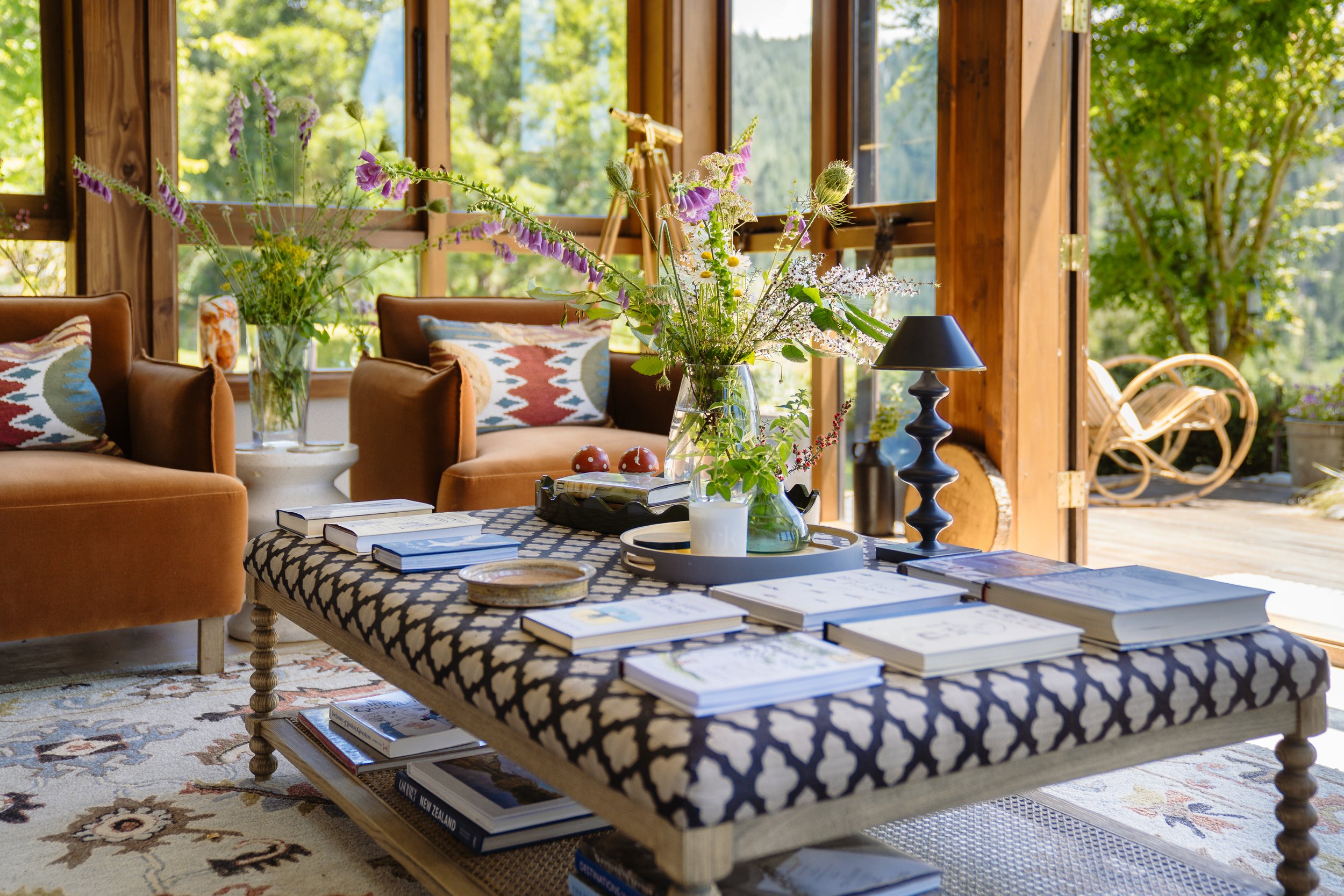 Sunlit lounge with fresh flowers at Stonefly Lodge