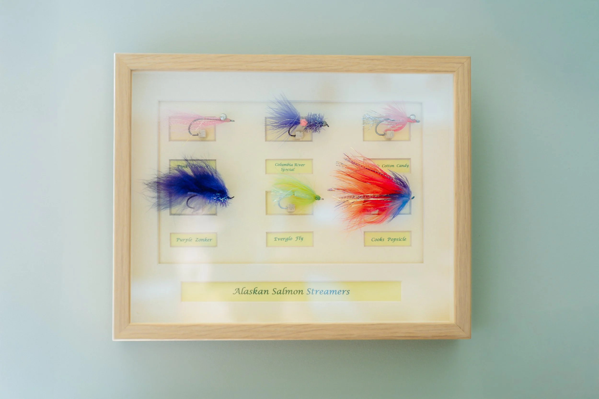 Framed hand-tied fishing flies displayed at Stonefly Lodge