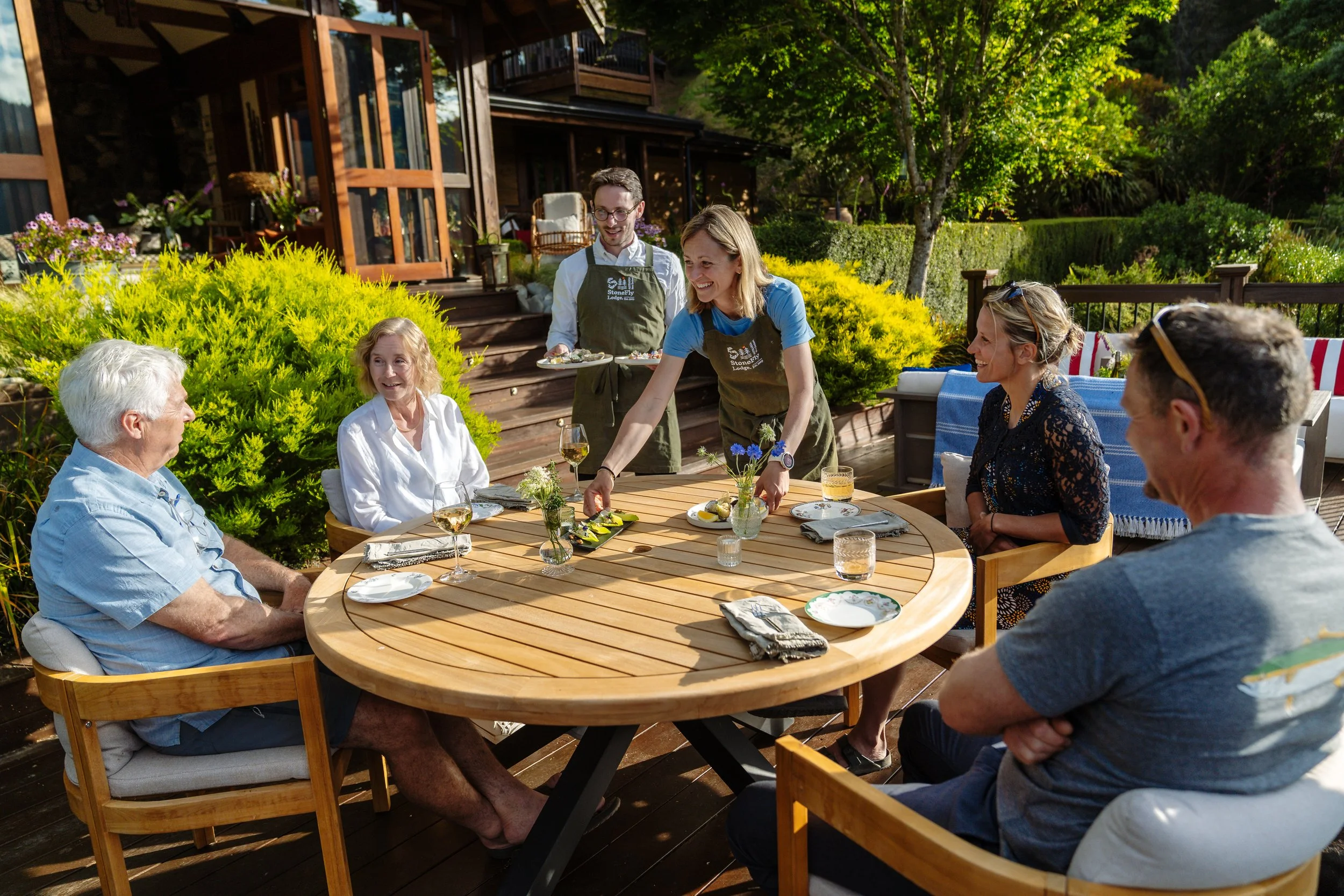 Guests enjoying canapés on the porch at Stonefly Lodge