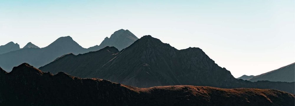 Layered mountain ridgelines at dawn